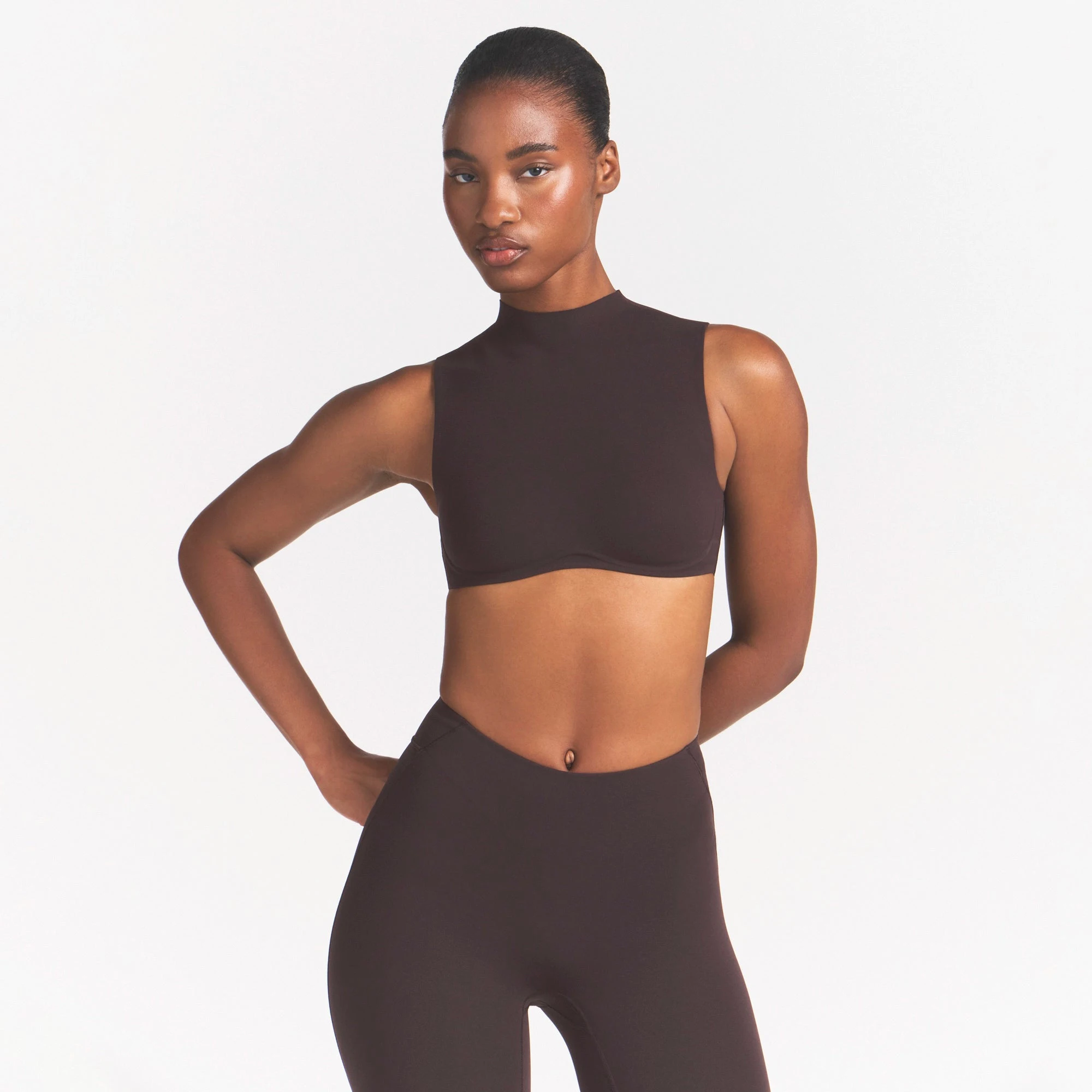 NikeSKIMS STUDIO STRETCH MOCK NECK BRA | DARK ROASTON A MODEL FRONT VIEW @ | FOCUS: 0.0, 1.0, 0.9