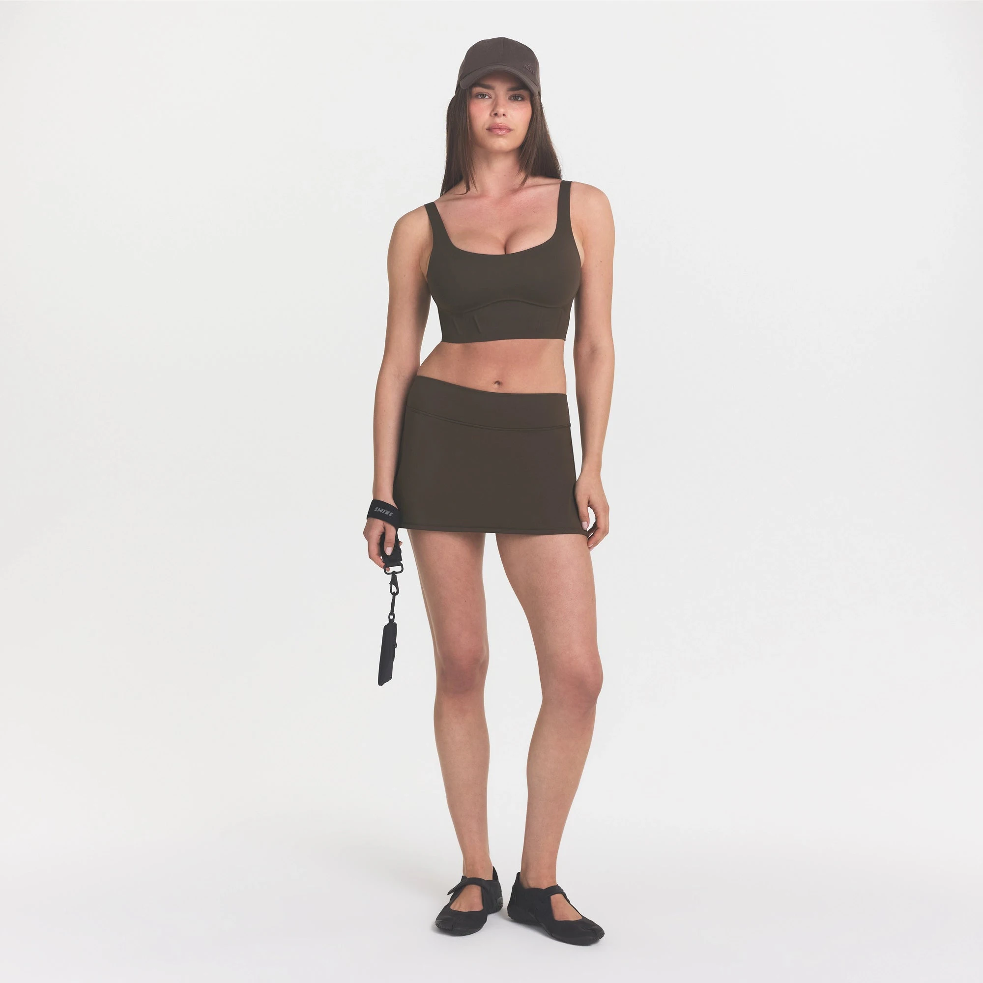 NikeSKIMS MATTE CORSET LONGLINE BRA | DARK SEPIA ON A MODEL