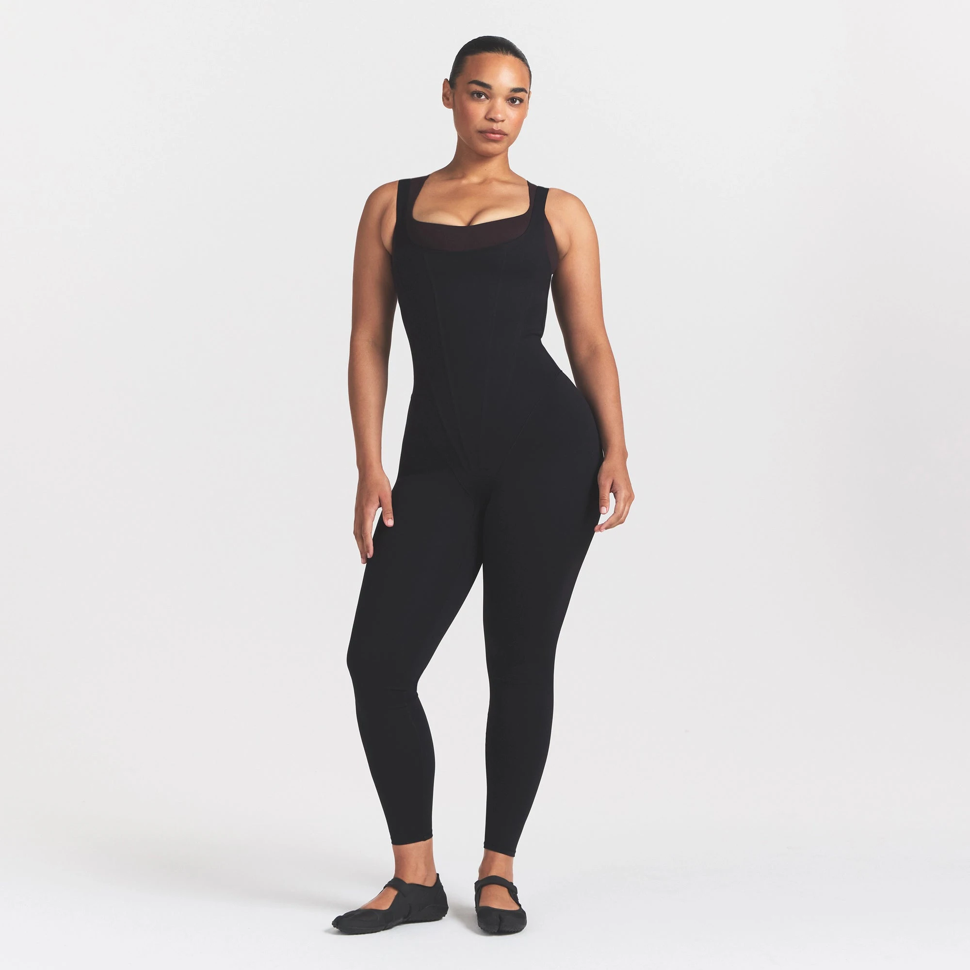 NikeSKIMS MATTE CORSET 29" ONE PIECE | OBSIDIAN ON A MODEL