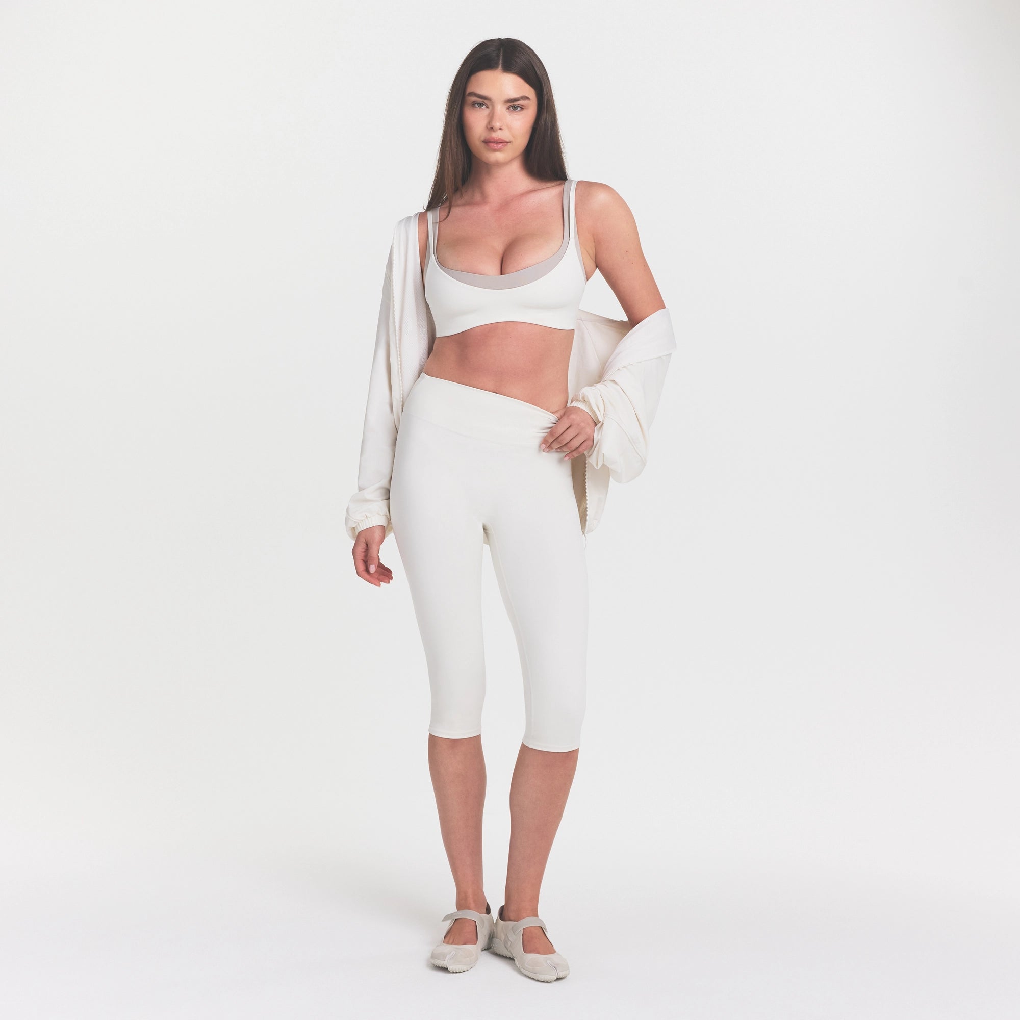 NikeSKIMS MATTE CROP 17" LEGGING | IVORY ON A MODEL 
