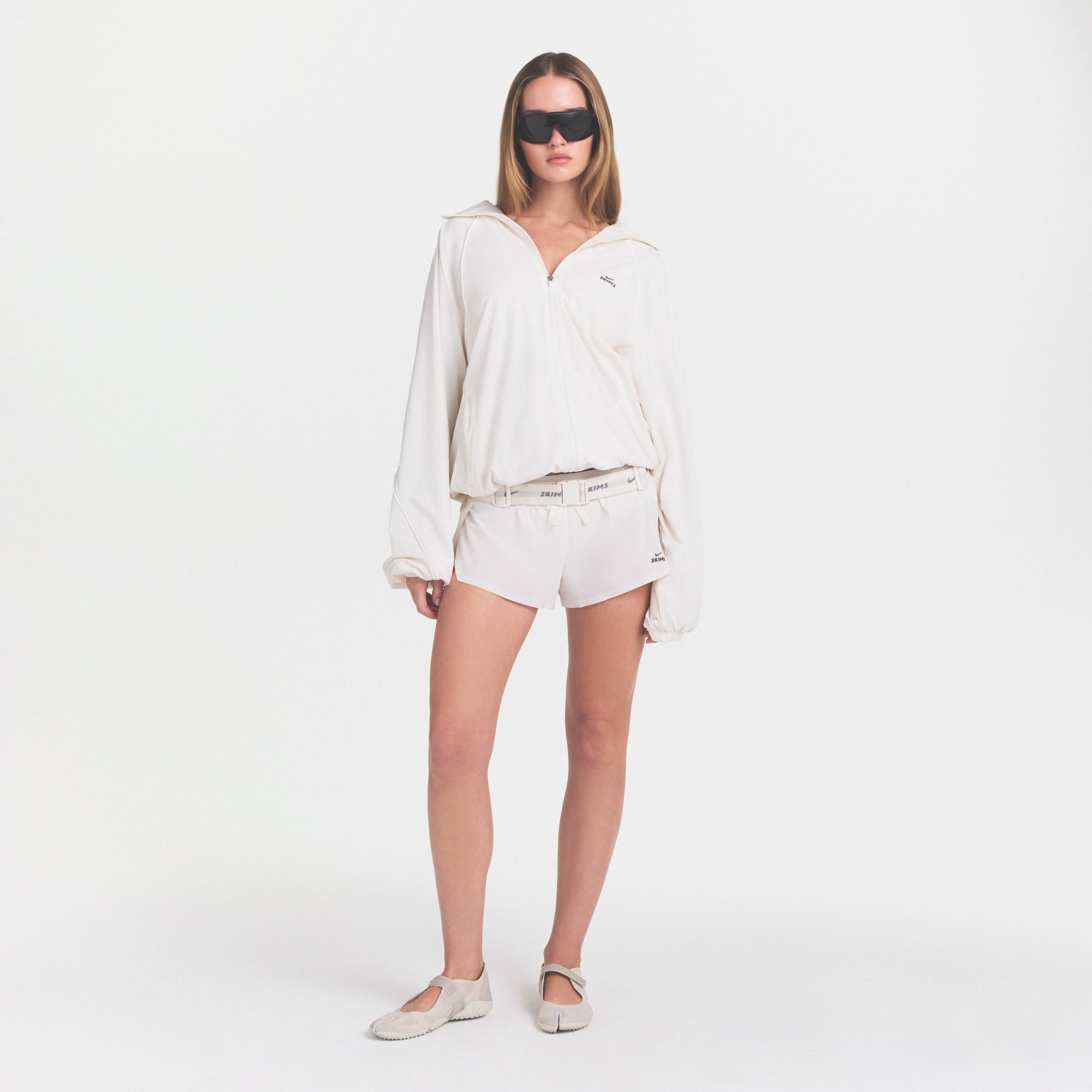 NikeSKIMS STRETCH NYLON OVERSIZED JACKET | IVORY ON A MODEL VIEW