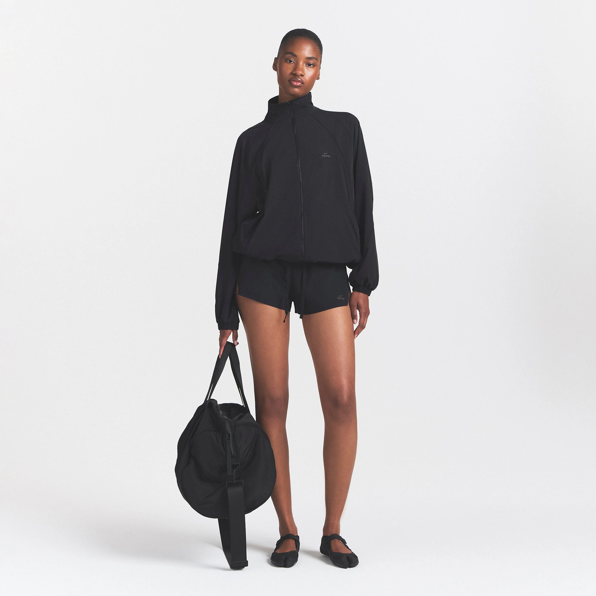 NikeSKIMS STRETCH NYLON OVERSIZED JACKET | OBSIDIAN ON A MODEL VIEW @ | FOCUS: 0.0, 1.0, 0.9
