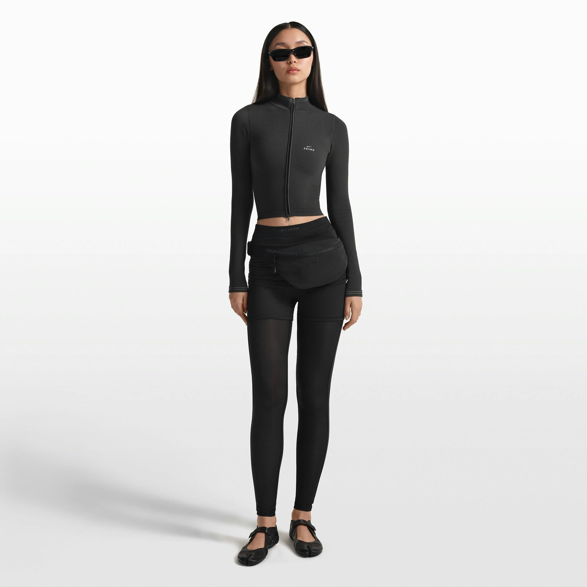 NikeSKIMS ACCESSORIES FANNY PACK | OBSIDIAN ON A MODEL FRONT VIEW @ | FOCUS: 0.0, 1.0, 0.9