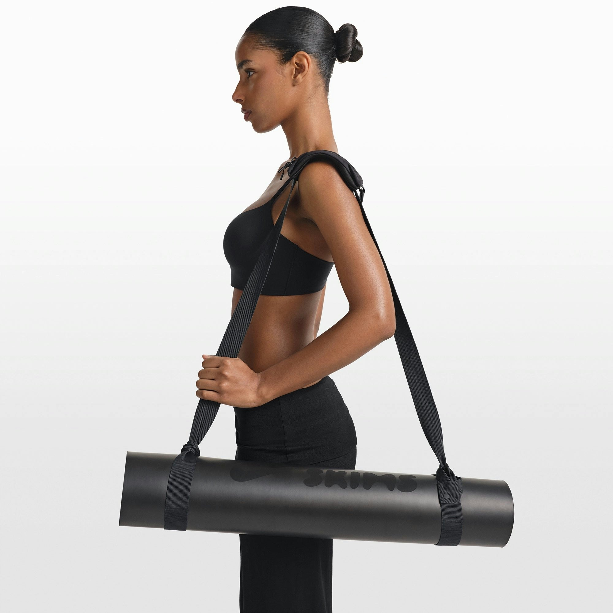 NikeSKIMS ACCESSORIES YOGA MAT STRAP | OBSIDIAN ON A MODEL FRONT VIEW @ | FOCUS: 0.0, 1.0, 0.9
