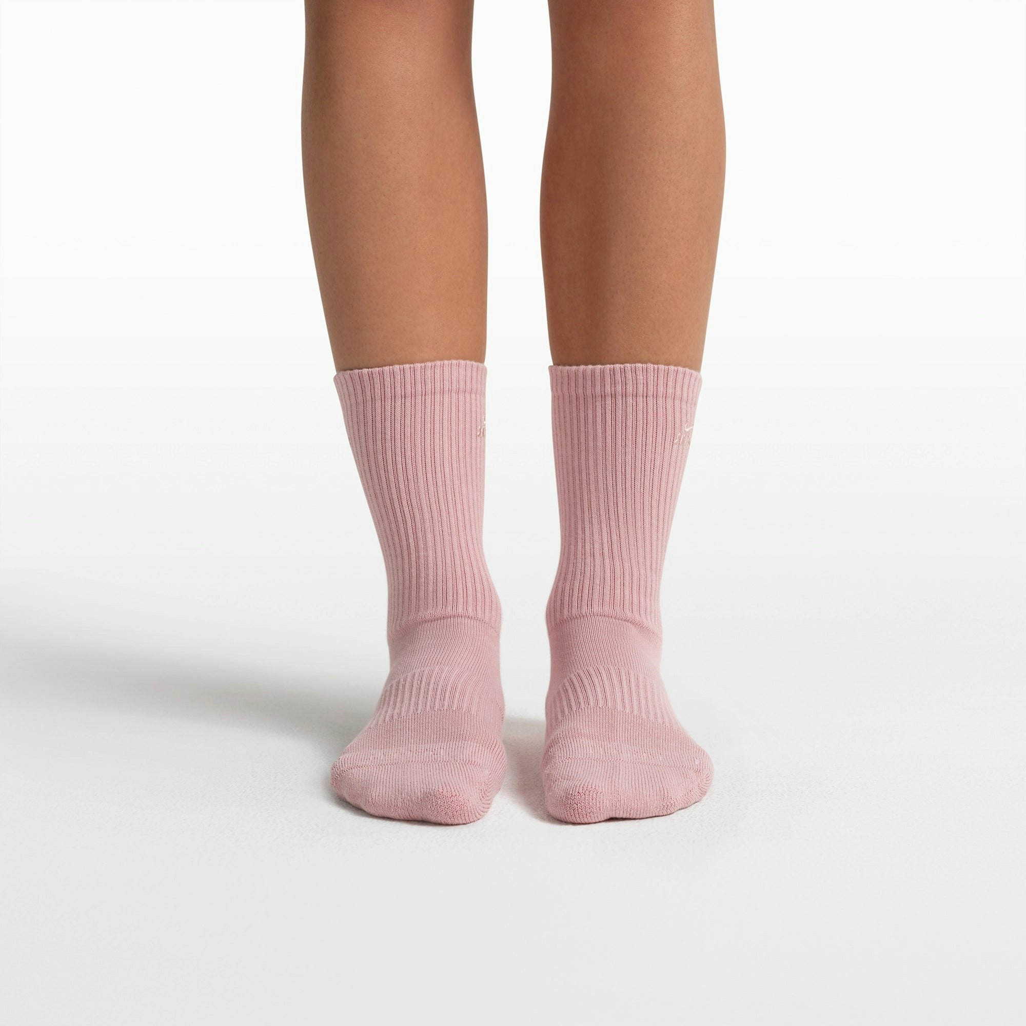 NikeSKIMS ACCESSORIES DRI-FIT PILATES GRIP CREW SOCK | HIMALAYAN FLAT ON A WHITE BACKGROUND