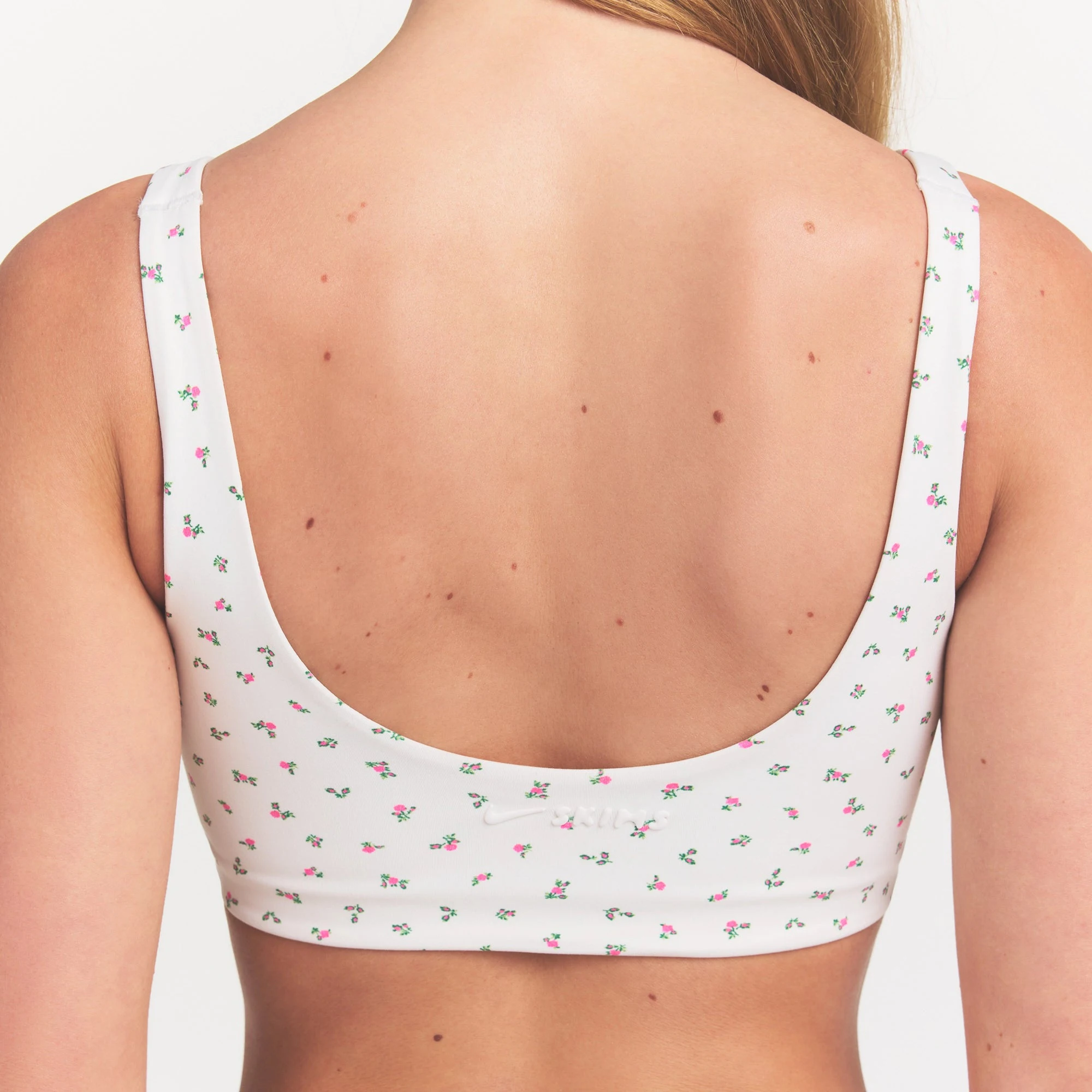 NikeSKIMS MATTE SCOOP NECK BRA | DITSY FLORAL PRINT ON A MODEL