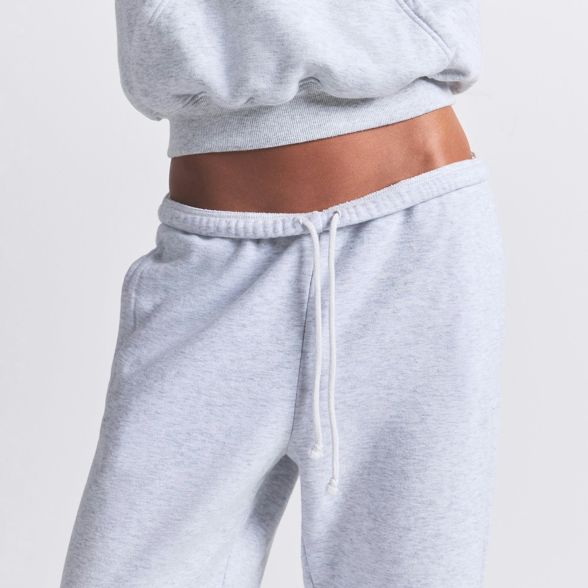 COTTON FLEECE CLASSIC JOGGER | LIGHT HEATHER GREY ON A MODEL FRONT VIEW | FOCUS: 0.0, 1.0, 0.9