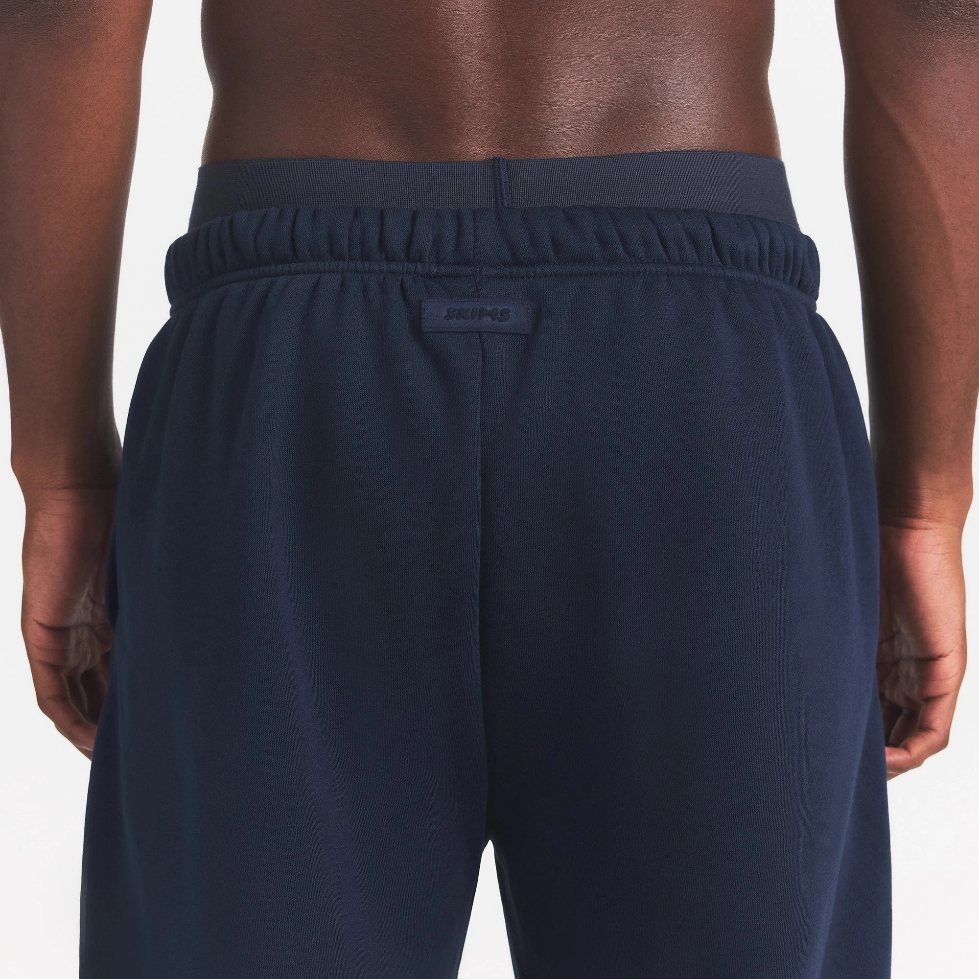 FLEECE LOUNGE MENS RELAXED JOGGER | NAVY ON A MODEL BACK VIEW | FOCUS: 0.0, 1.0, 0.9