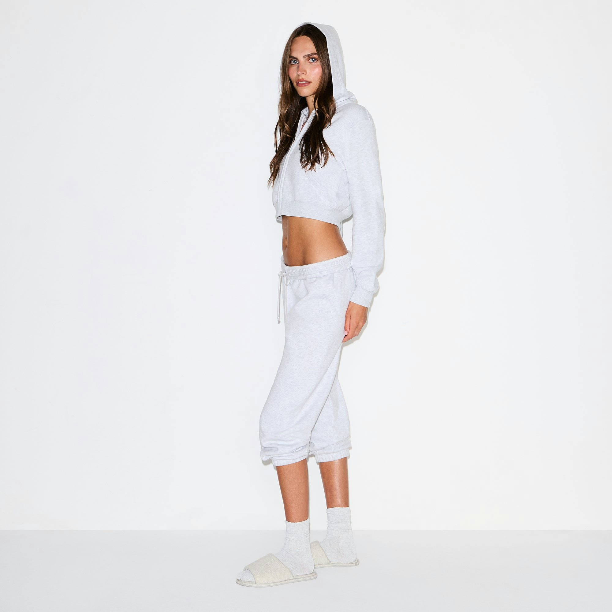 COTTON FLEECE LOW RISE CAPRI JOGGER | LIGHT HEATHER GREY ON A MODEL SIDE VIEW @ | FOCUS: 0.0, 1.0, 0.9