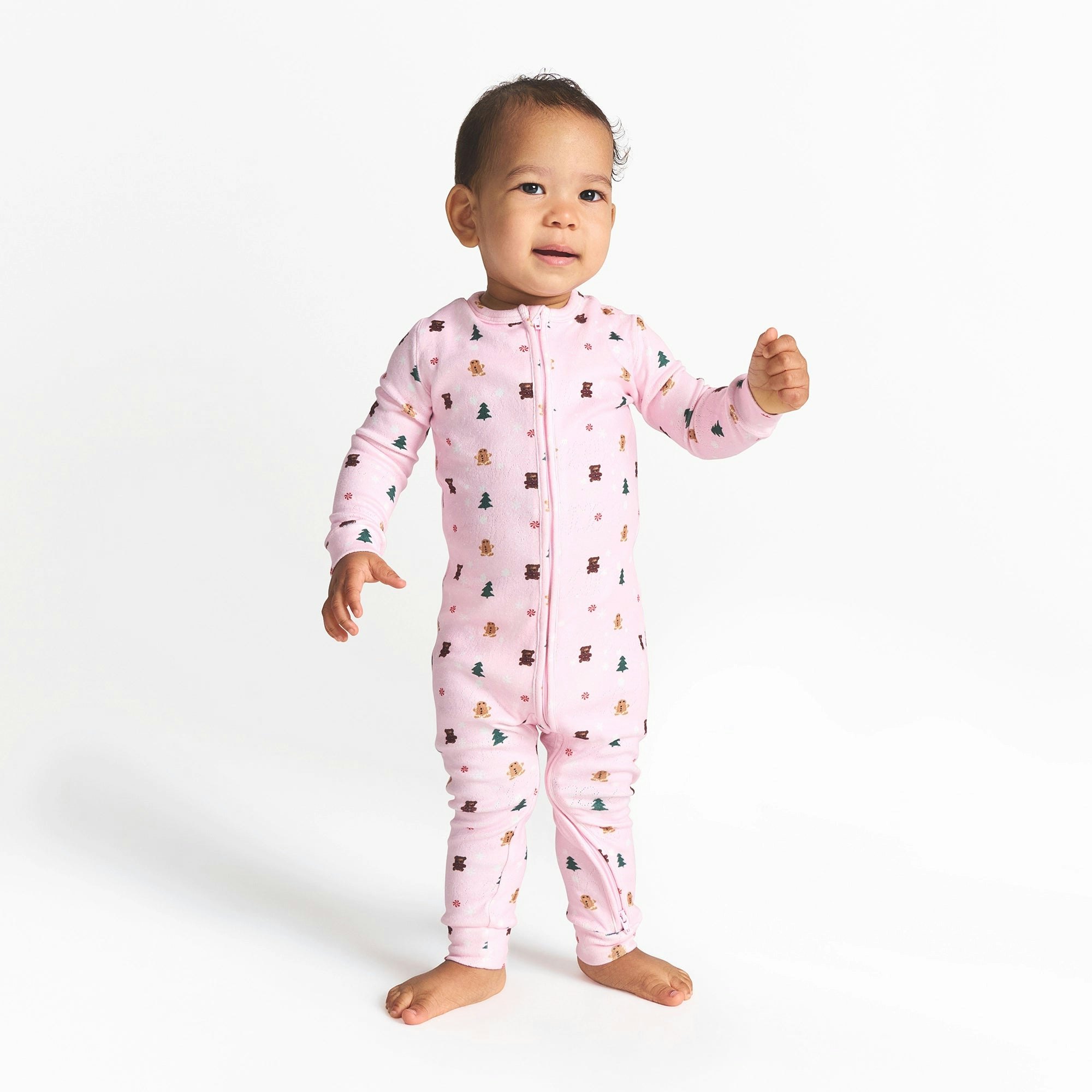 CACTUS PLANT FLEA MARKET X SKIMS PLUSH POINTELLE BABY ONESIE | CHERRY BLOSSOM SNOW PRINT ON A MODEL FRONT VIEW @ | FOCUS: 0.0, 1.0, 0.9