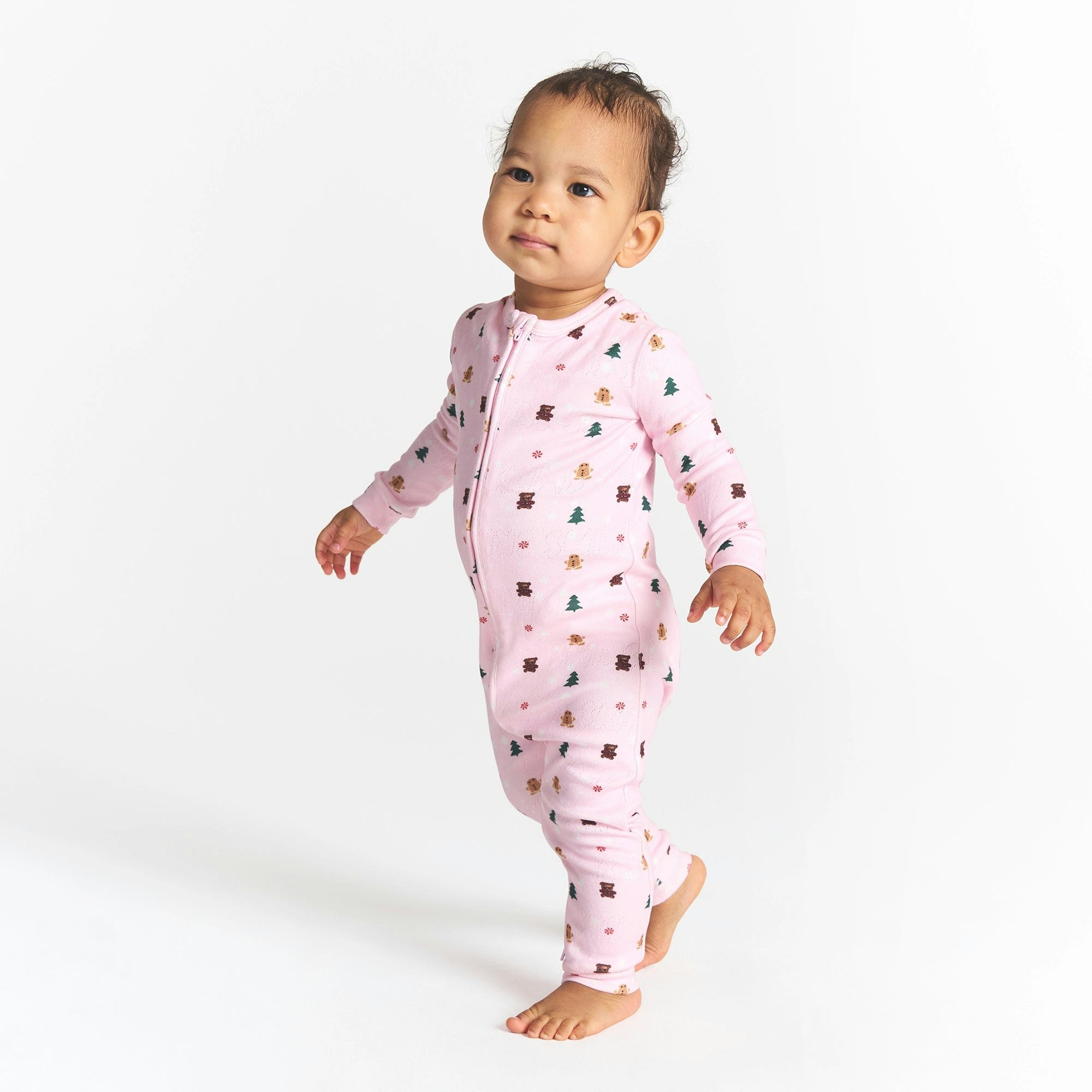 CACTUS PLANT FLEA MARKET X SKIMS PLUSH POINTELLE BABY ONESIE | CHERRY BLOSSOM SNOW PRINT ON A MODEL SIDE VIEW @ | FOCUS: 0.0, 1.0, 0.9