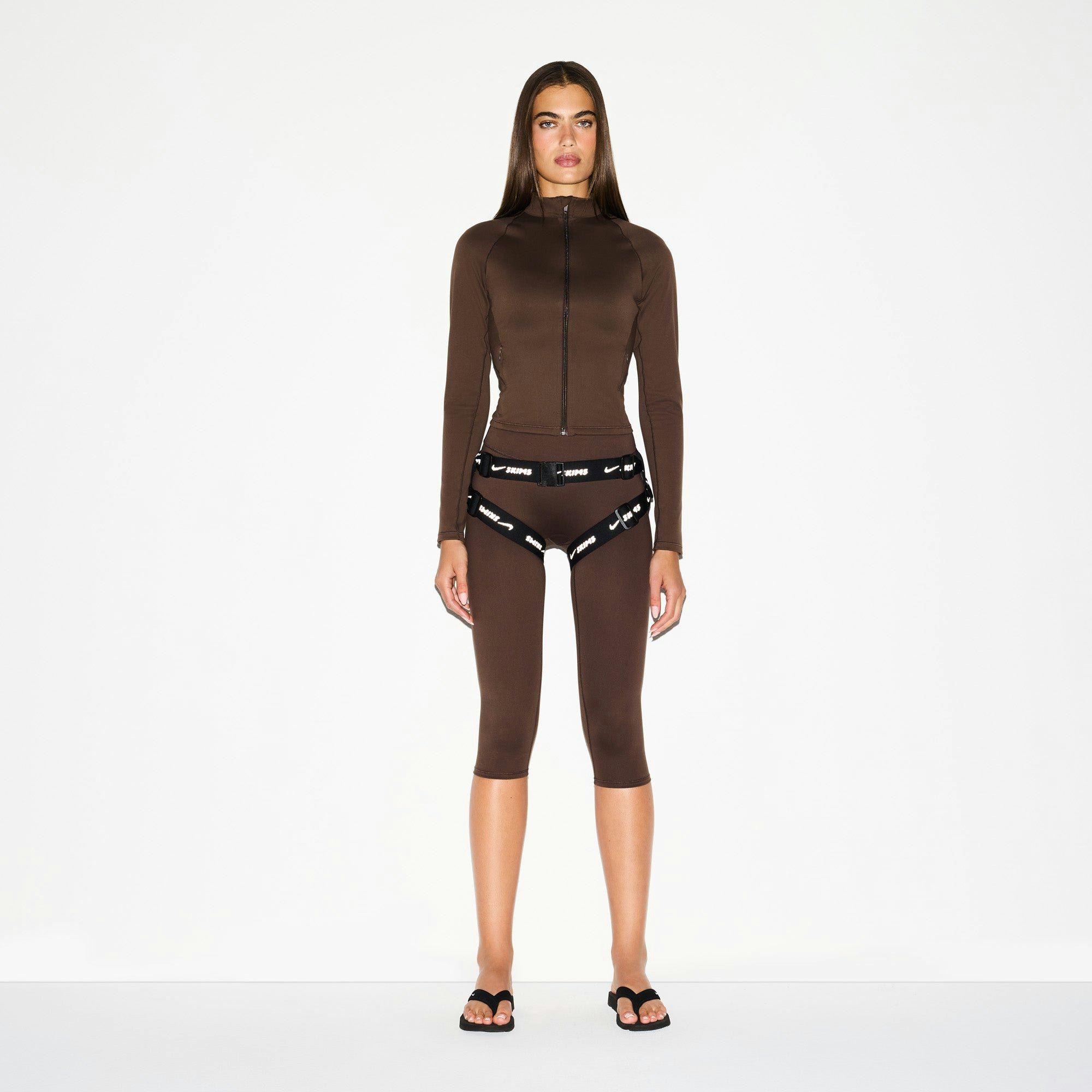 NikeSKIMS MATTE CROP 17" LEGGING | DARK SEPIA ON A MODEL FRONT VIEW @ | FOCUS: 0.0, 1.0, 0.9