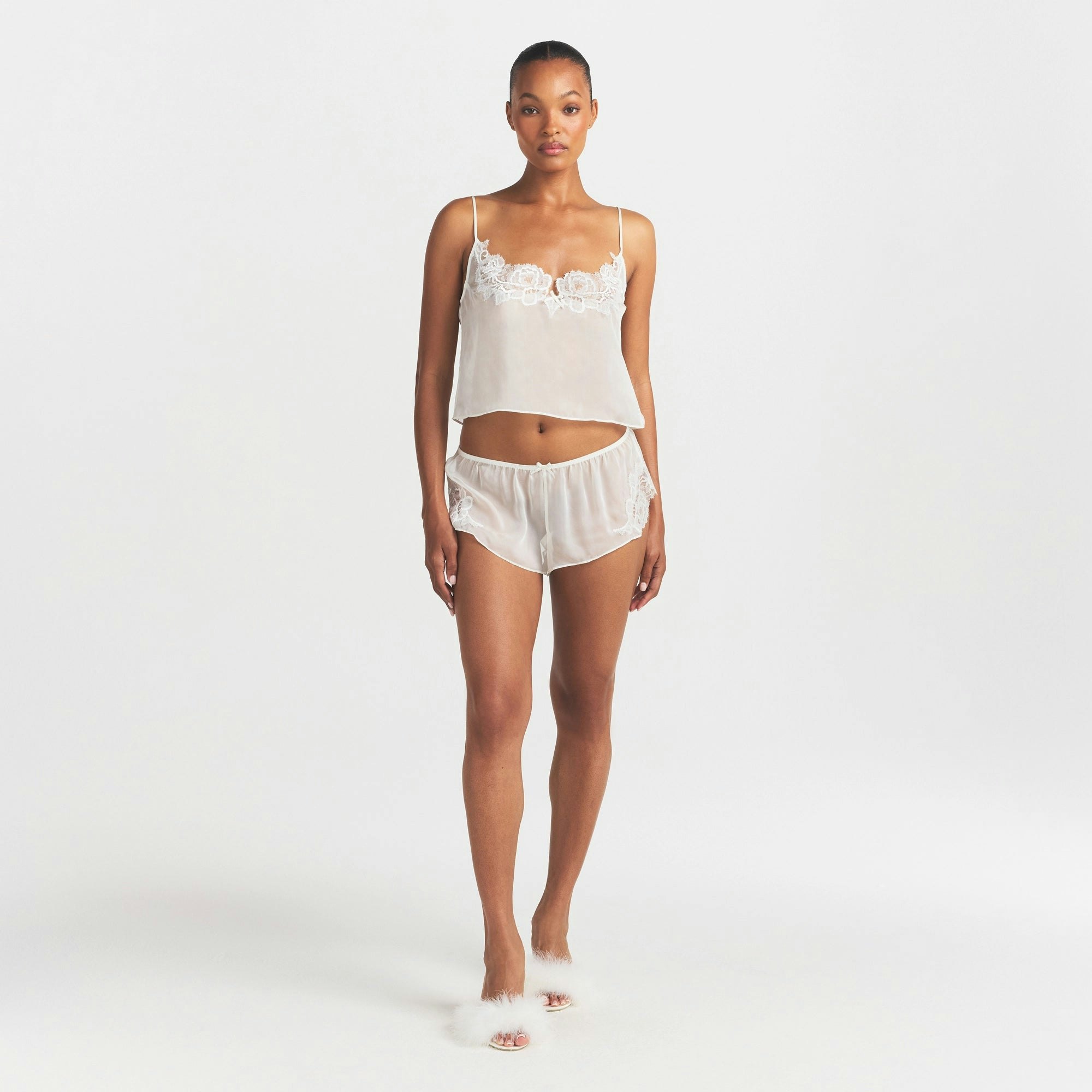 SKIMS ROMANCE CAMI AND SHORT SET | IVORY ON A MODEL FRONT VIEW @ | FOCUS: 0.0, 1.0, 0.9