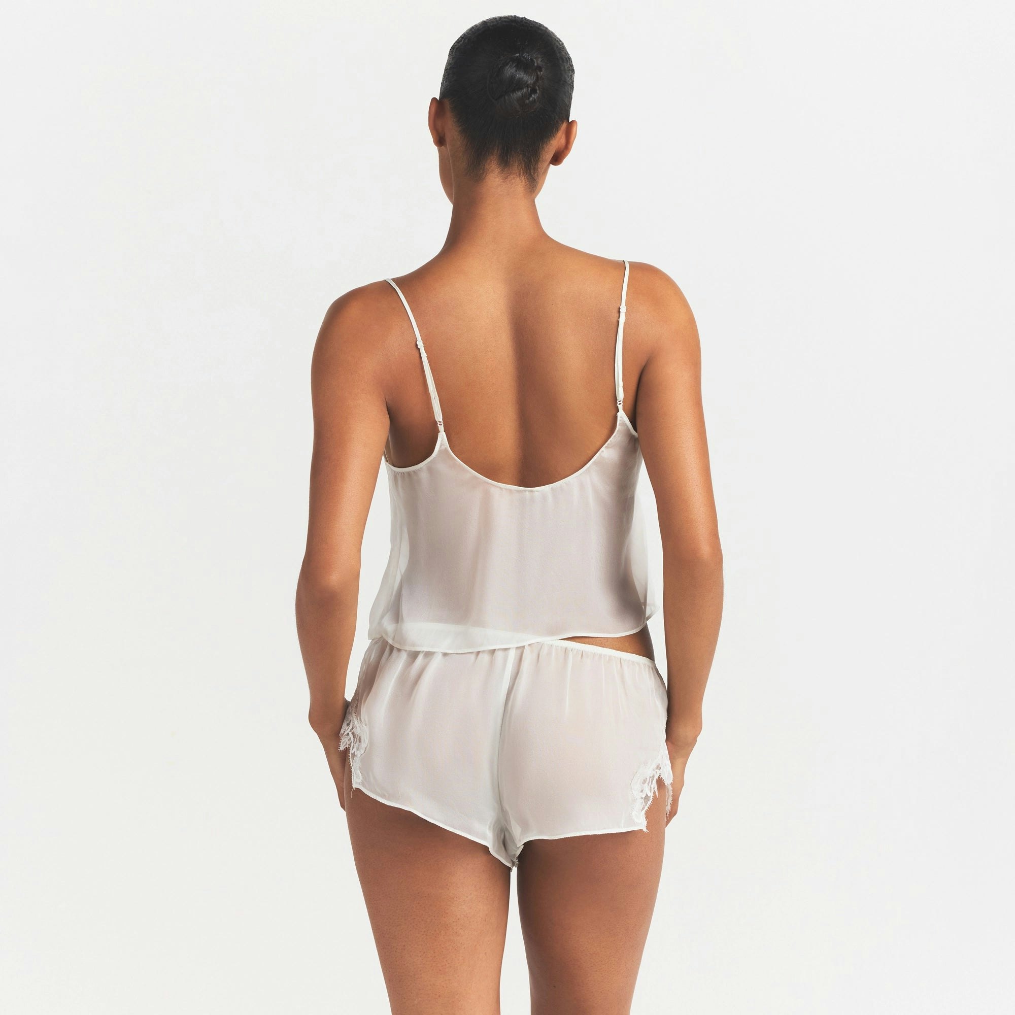 SKIMS ROMANCE CAMI AND SHORT SET | IVORY ON A MODEL SIDE VIEW @ | FOCUS: 0.0, 1.0, 0.9