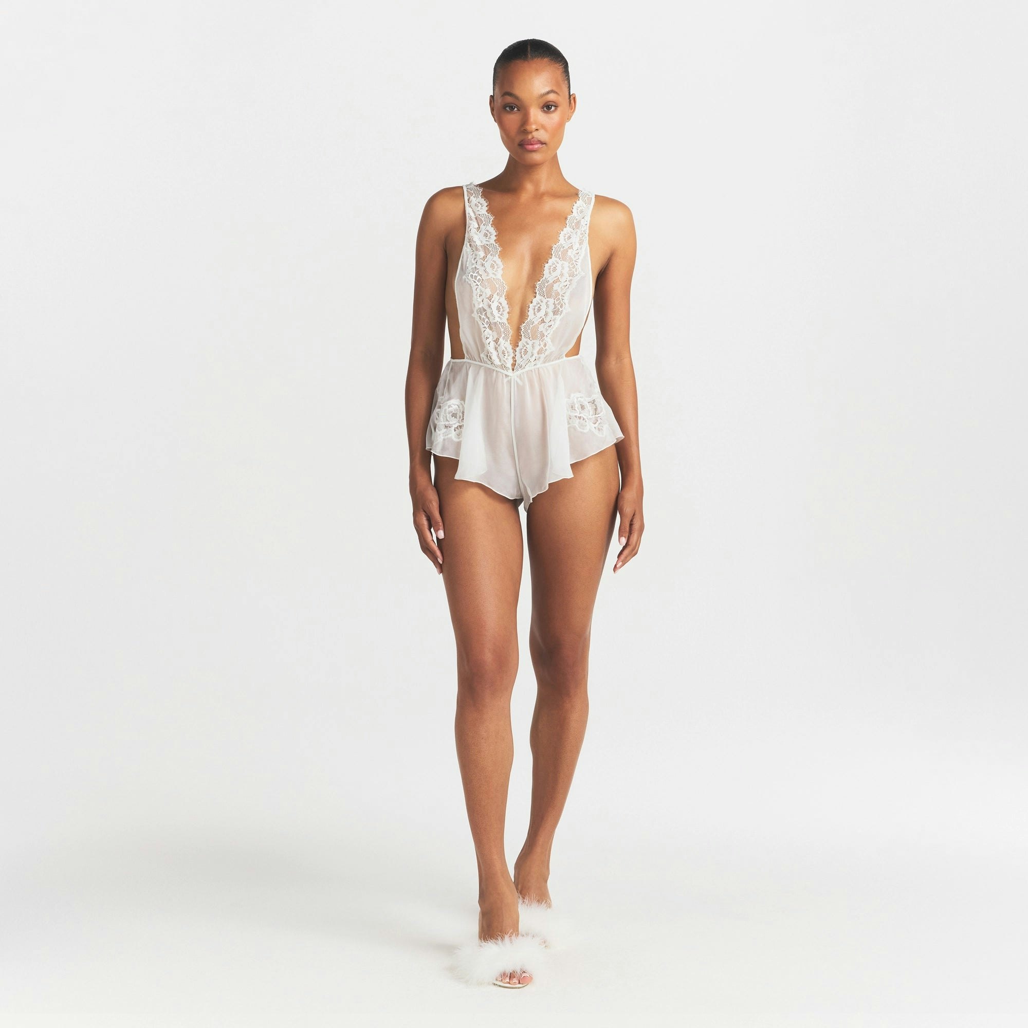 SKIMS ROMANCE PLUNGE TEDDY | IVORY ON A MODEL FRONT VIEW @ | FOCUS: 0.0, 1.0, 0.9