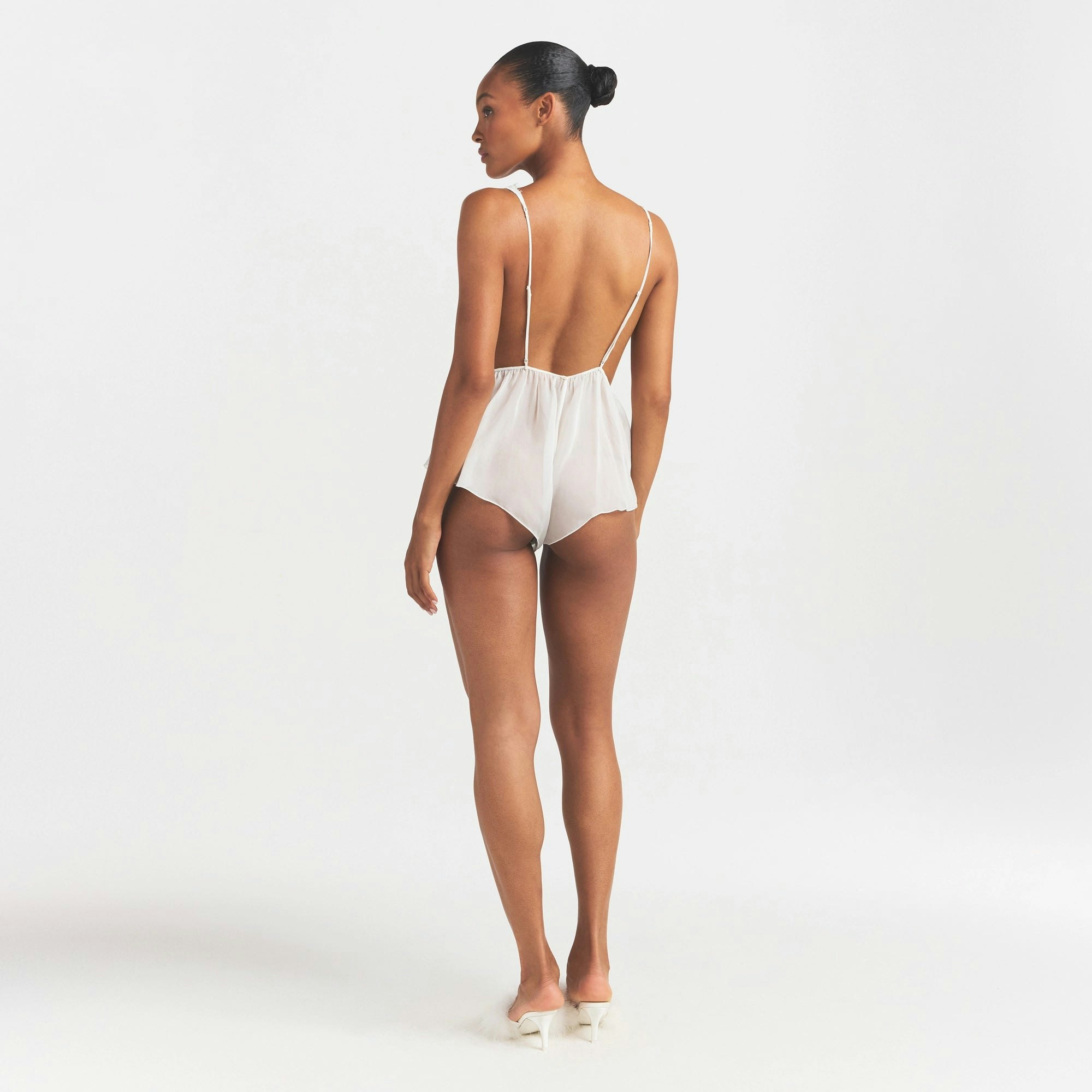 SKIMS ROMANCE PLUNGE TEDDY | IVORY ON A MODEL FRONT VIEW @ | FOCUS: 0.0, 1.0, 0.9