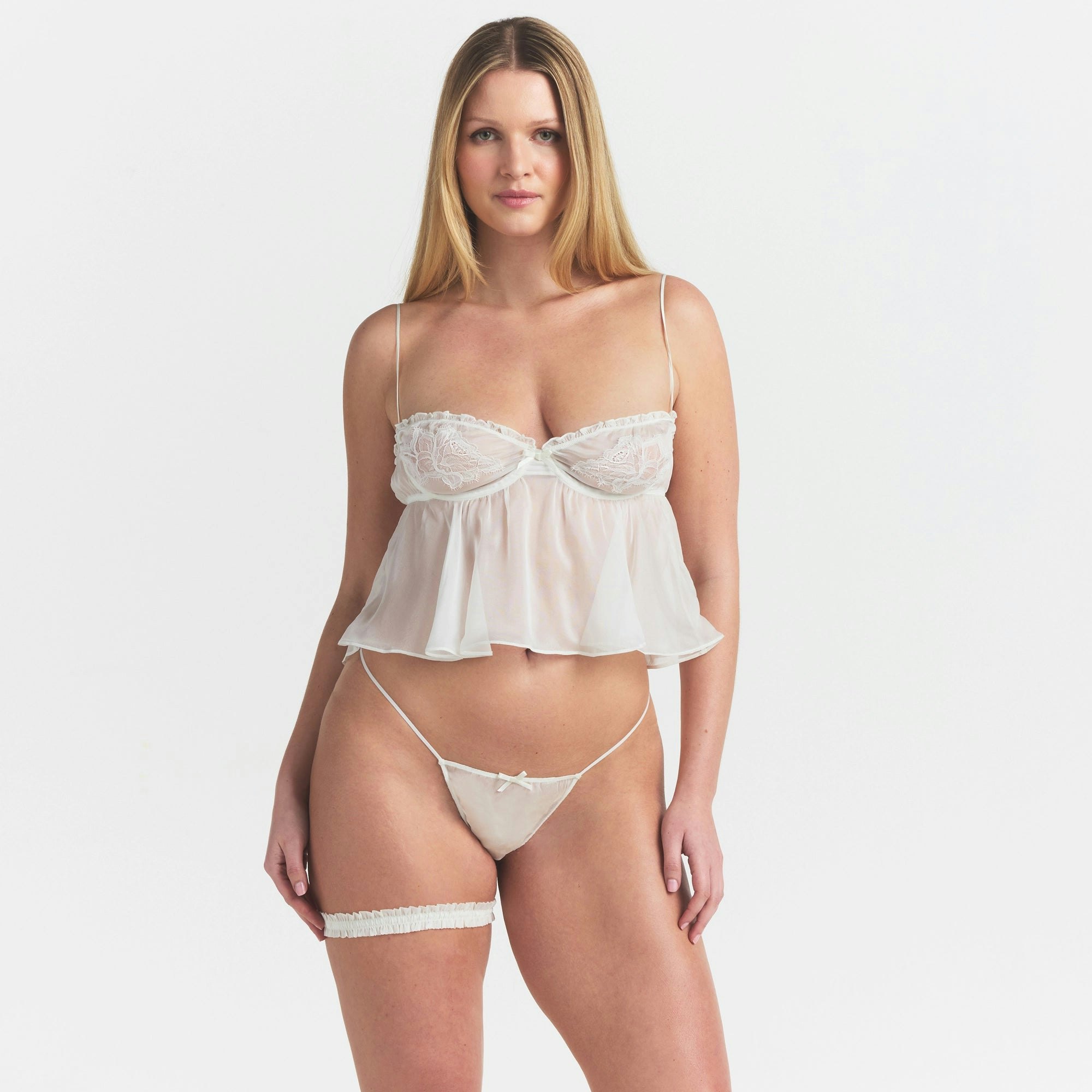 SKIMS ROMANCE BABYDOLL TOP AND STRING THONG SET | IVORY ON A MODEL SIDE VIEW @ | FOCUS: 0.0, 1.0, 0.9
