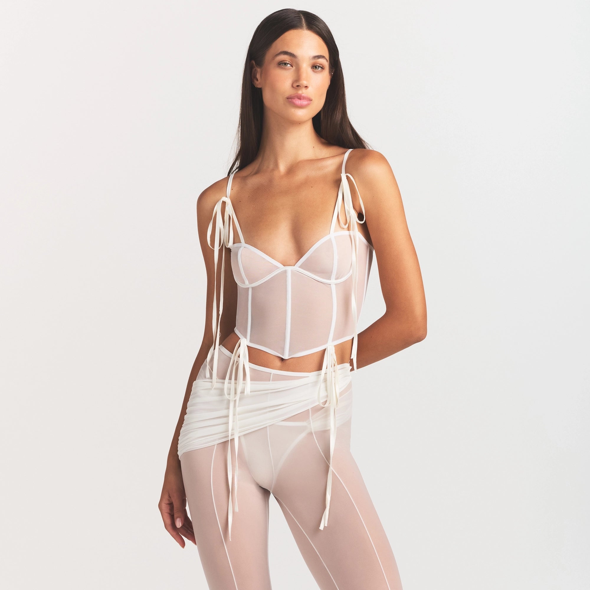 ULTRA FINE MESH BOW CORSET | IVORY ON A MODEL SIDE VIEW @ | FOCUS: 0.0, 1.0, 0.9