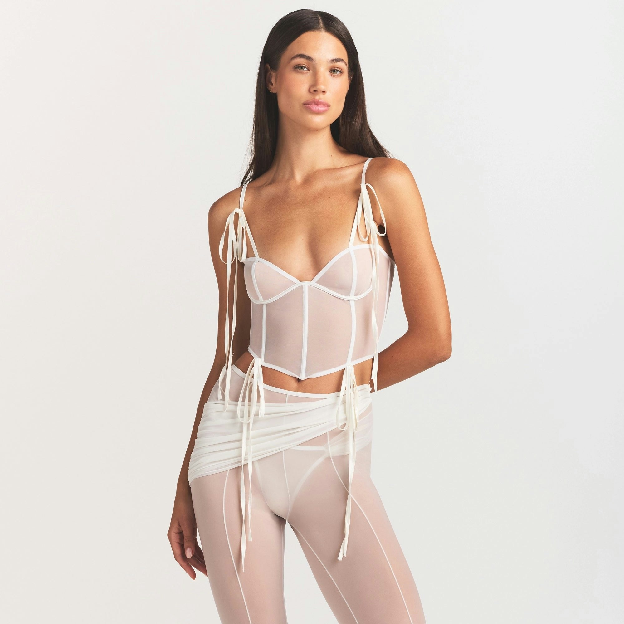 ULTRA FINE MESH BOW CORSET | IVORY ON A MODEL SIDE VIEW @ | FOCUS: 0.0, 1.0, 0.9