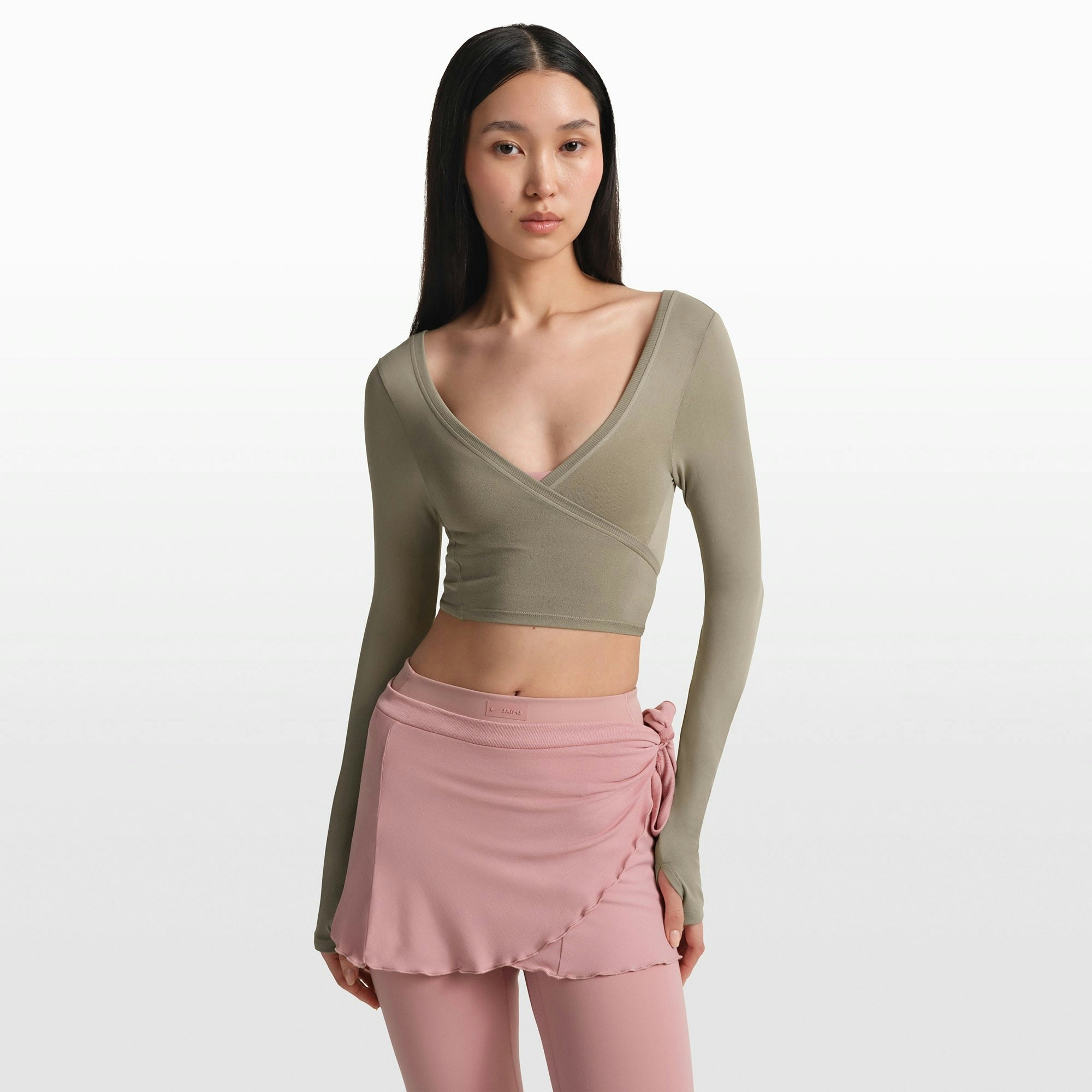 NikeSKIMS STRETCH KNIT WRAP LONG SLEEVE CROPPED TOP | DUNE ON A MODEL FRONT VIEW @ | FOCUS: 0.0, 1.0, 0.9