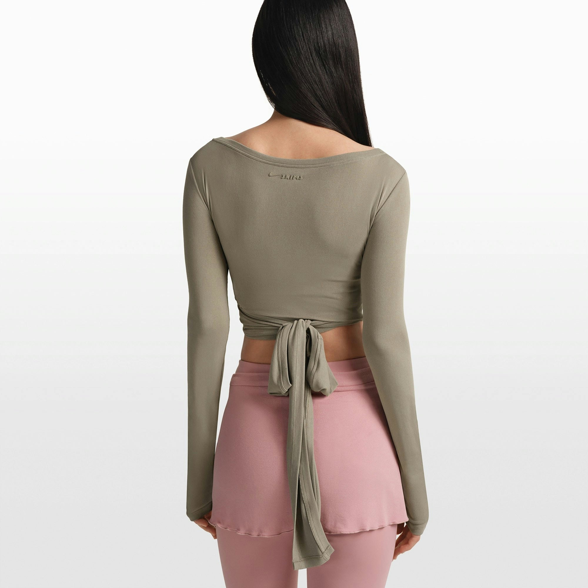NikeSKIMS STRETCH KNIT WRAP LONG SLEEVE CROPPED TOP | DUNE ON A MODEL FRONT VIEW @ | FOCUS: 0.0, 1.0, 0.9