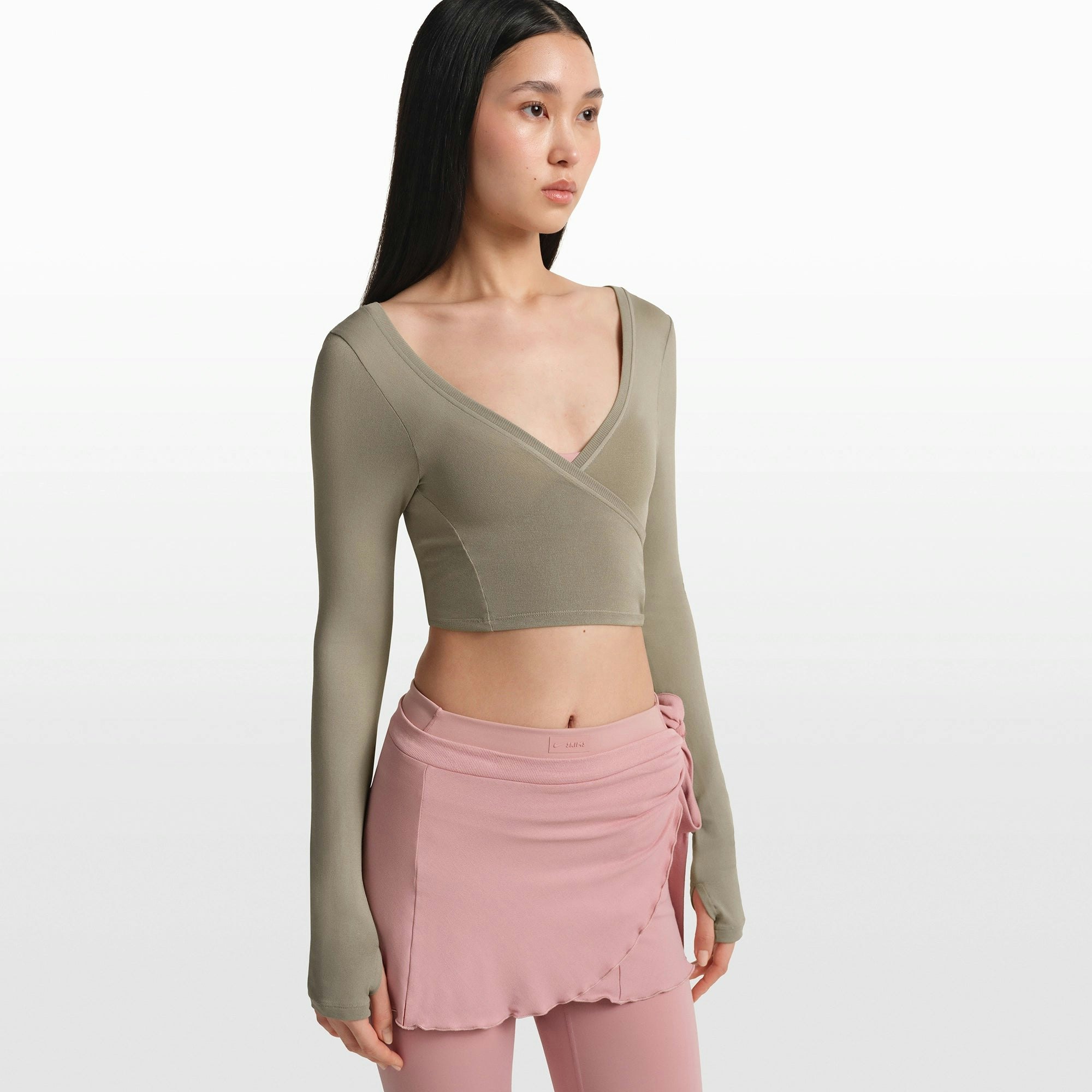 NikeSKIMS STRETCH KNIT WRAP LONG SLEEVE CROPPED TOP | DUNE ON A MODEL FRONT VIEW @ | FOCUS: 0.0, 1.0, 0.9