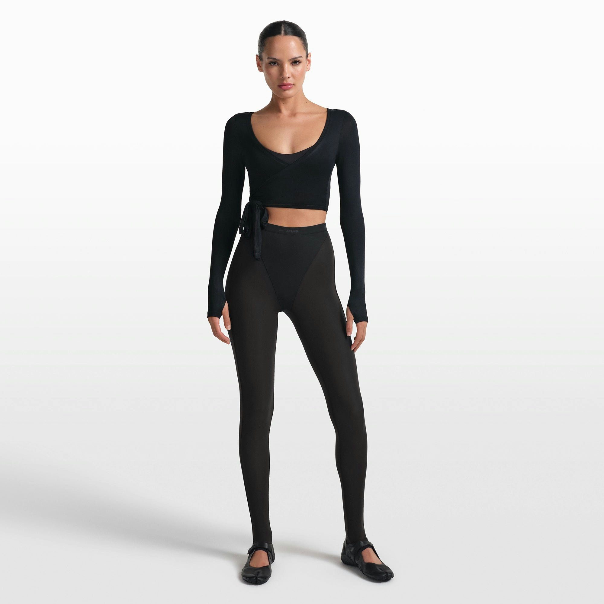 NikeSKIMS STRETCH KNIT WRAP LONG SLEEVE CROPPED TOP | OBSIDIAN ON A MODEL FRONT VIEW @ | FOCUS: 0.0, 1.0, 0.9