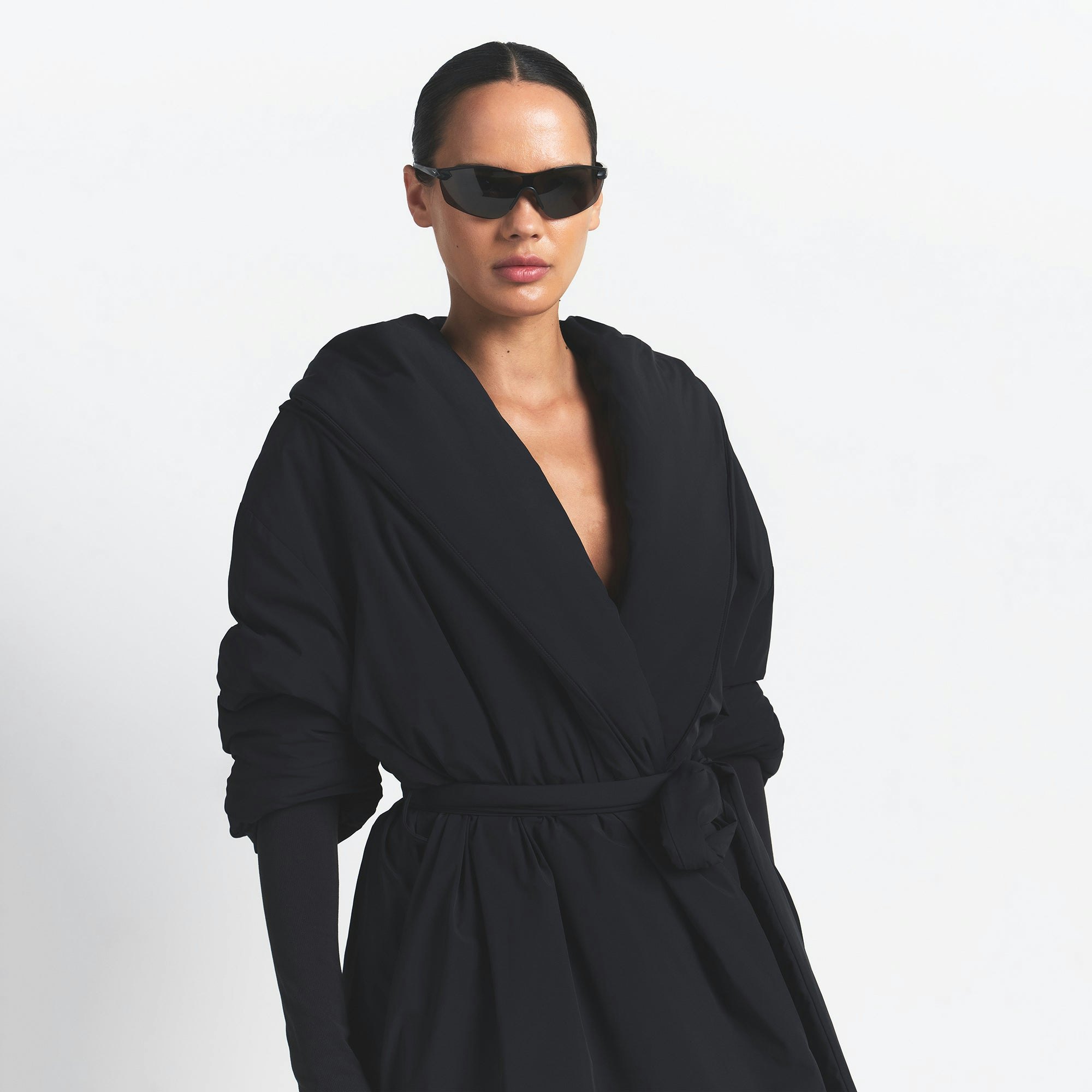 NikeSKIMS WOVEN NYLON WRAP COAT | OBSIDIAN ON A MODEL FRONT VIEW @ | FOCUS: 0.0, 1.0, 0.9