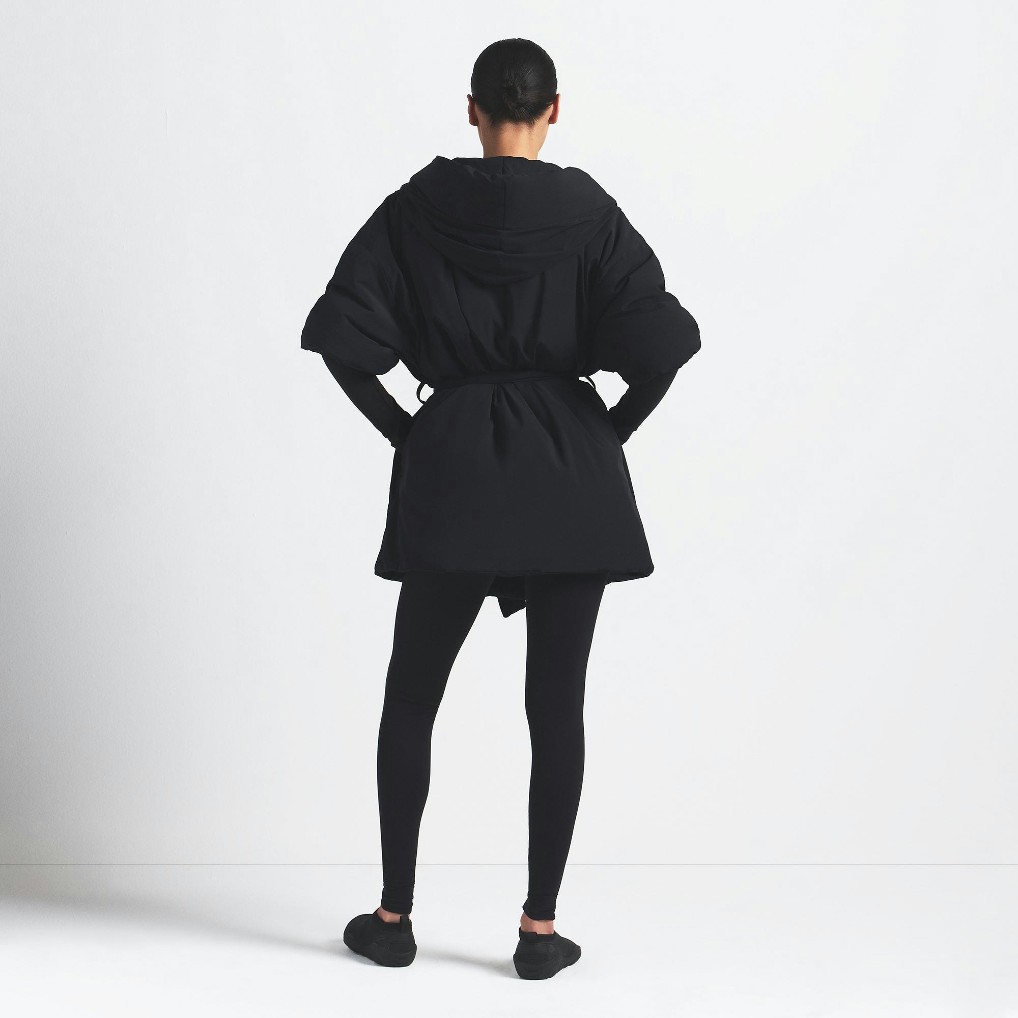 NikeSKIMS WOVEN NYLON WRAP COAT | OBSIDIAN ON A MODEL BACK VIEW @ | FOCUS: 0.0, 1.0, 0.9