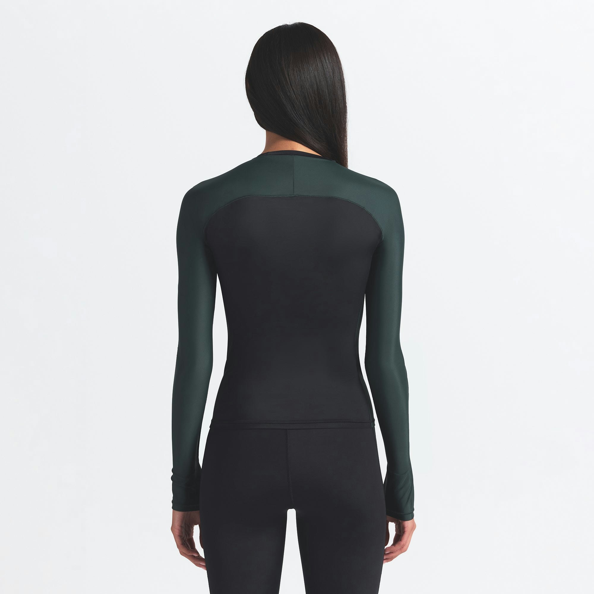 NikeSKIMS SHINE LONG SLEEVE CREW NECK | OBSIDIAN AND DARK TEAL ON A MODEL BACK VIEW @ | FOCUS: 0.0, 1.0, 0.9