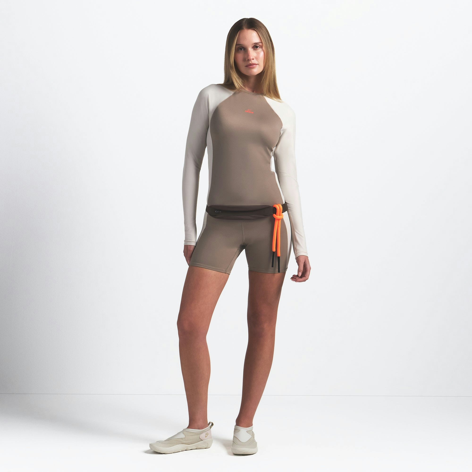 NikeSKIMS SHINE LONG SLEEVE CREW NECK | TRUFFLE AND STONE ON A MODEL FRONT VIEW @ | FOCUS: 0.0, 1.0, 0.9