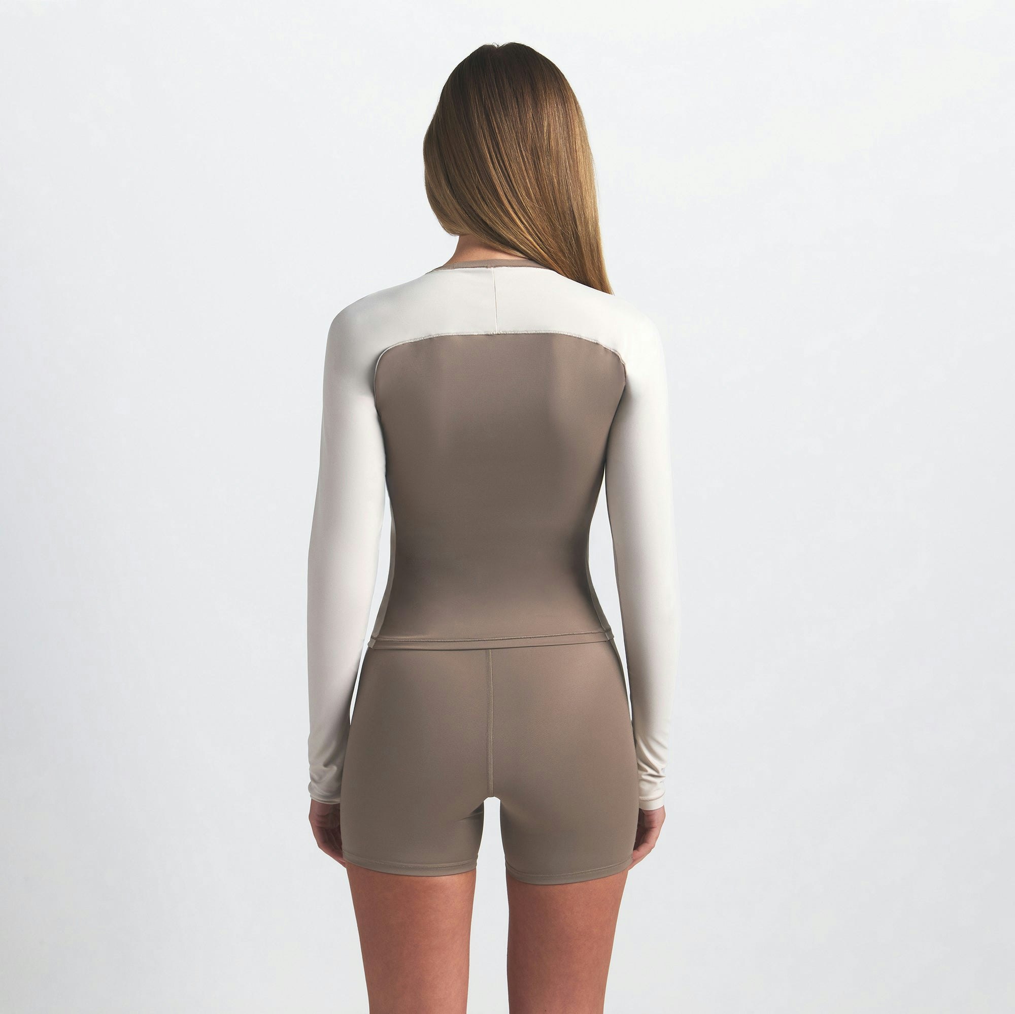 NikeSKIMS SHINE LONG SLEEVE CREW NECK | TRUFFLE AND STONE ON A MODEL BACK VIEW @ | FOCUS: 0.0, 1.0, 0.9