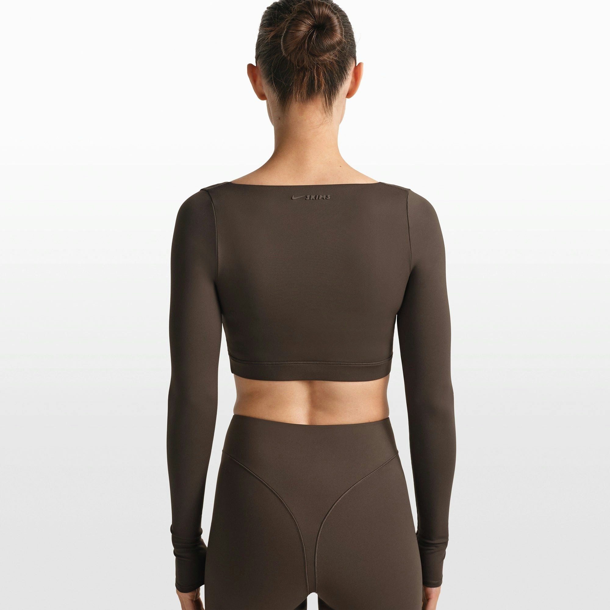 NikeSKIMS MATTE WRAP LONG SLEEVE CROPPED TOP | DARK SEPIA ON A MODEL FRONT VIEW @ | FOCUS: 0.0, 1.0, 0.9
