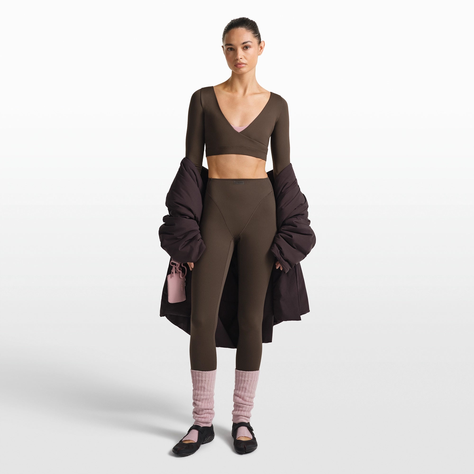 NikeSKIMS MATTE WRAP LONG SLEEVE CROPPED TOP | DARK SEPIA ON A MODEL FRONT VIEW @ | FOCUS: 0.0, 1.0, 0.9