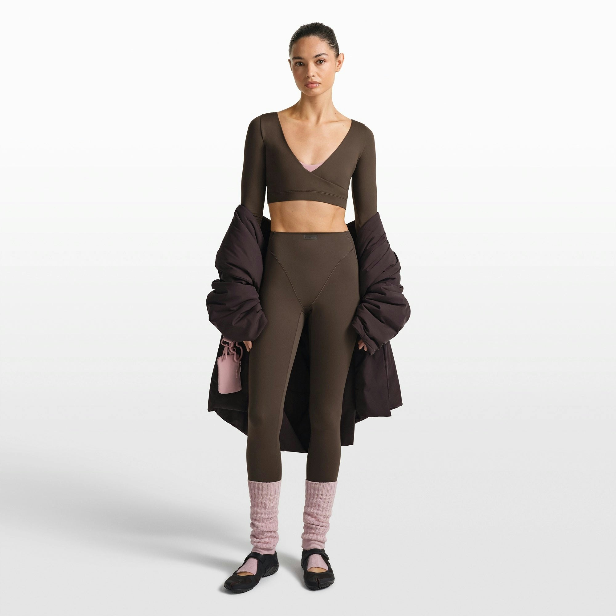 NikeSKIMS MATTE WRAP LONG SLEEVE CROPPED TOP | DARK SEPIA ON A MODEL FRONT VIEW @ | FOCUS: 0.0, 1.0, 0.9