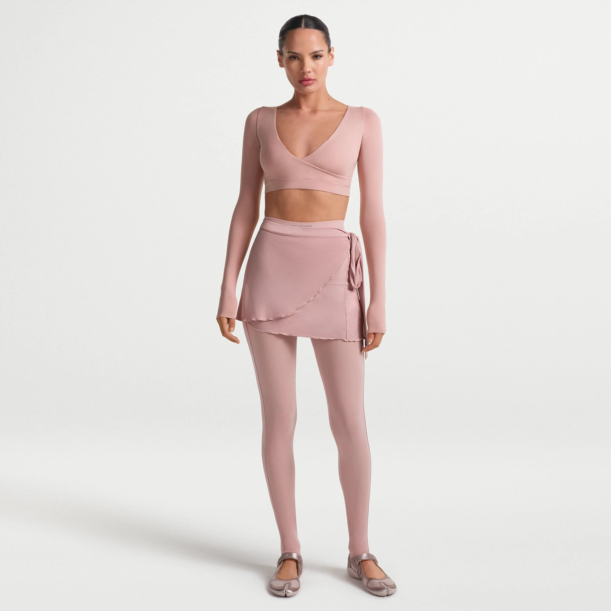 NikeSKIMS MATTE WRAP LONG SLEEVE CROPPED TOP | HIMALAYAN ON A MODEL FRONT VIEW @ | FOCUS: 0.0, 1.0, 0.9