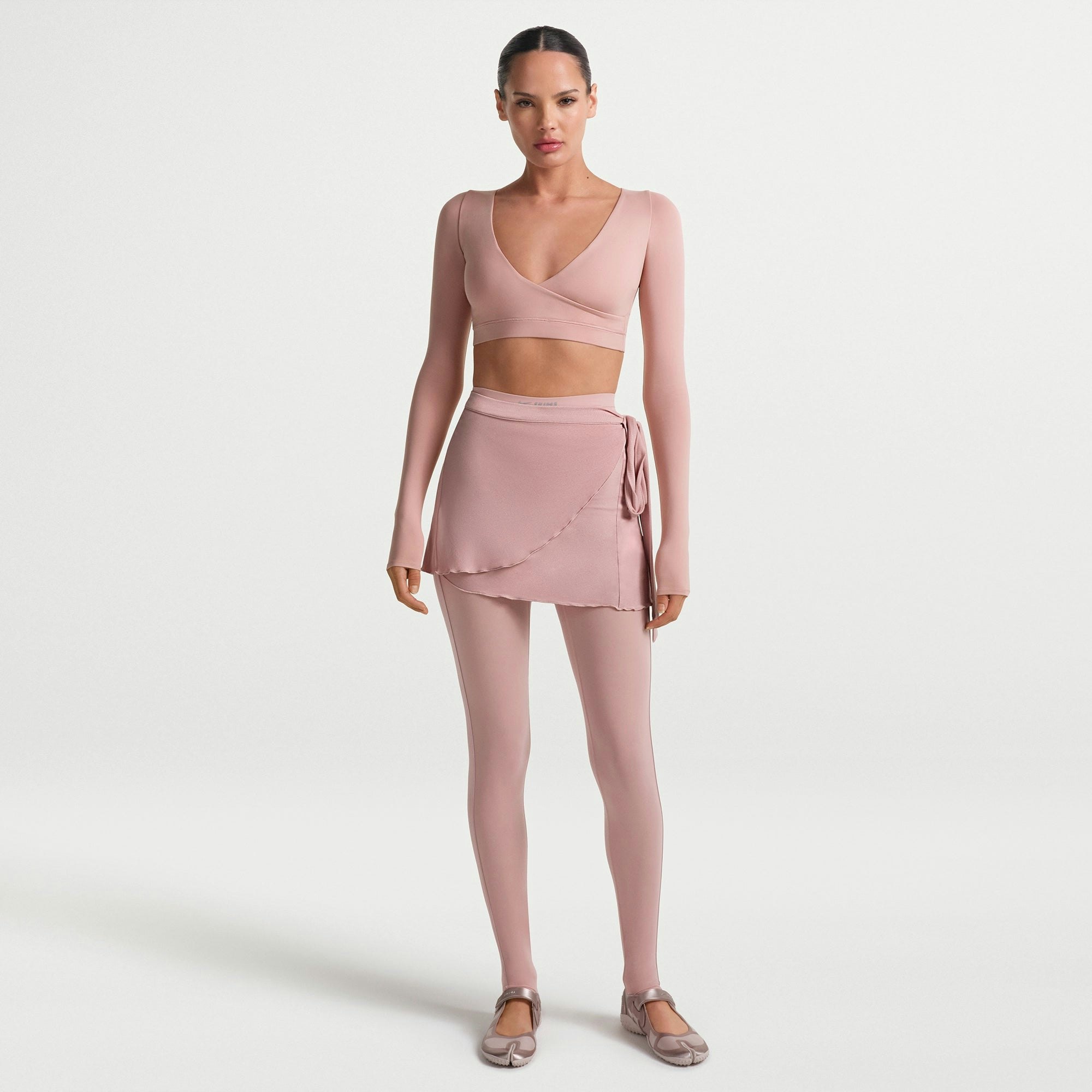 NikeSKIMS MATTE WRAP LONG SLEEVE CROPPED TOP | HIMALAYAN ON A MODEL FRONT VIEW @ | FOCUS: 0.0, 1.0, 0.9