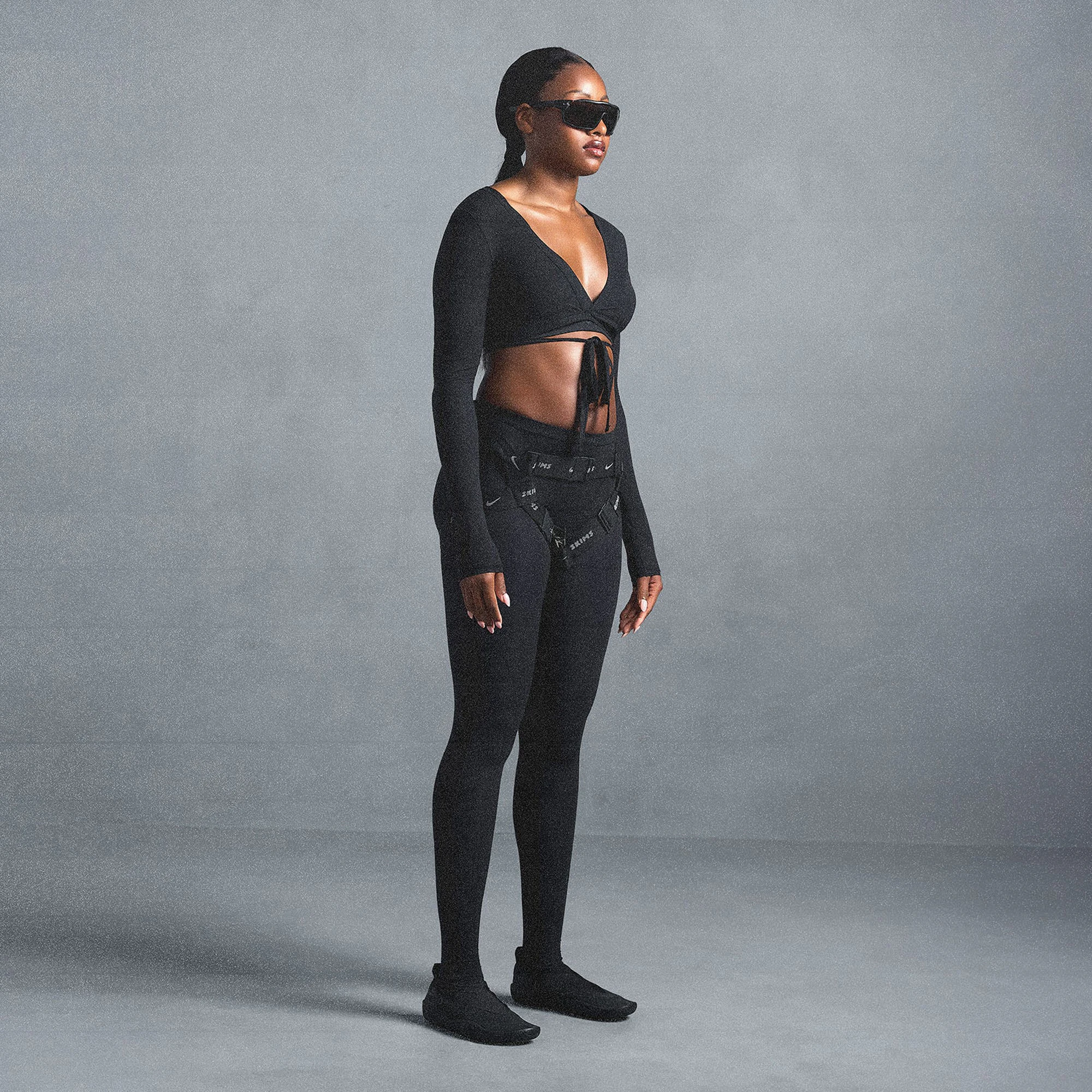 NikeSKIMS WEIGHTLESS LAYERS WRAP TOP | OBSIDIAN ON A MODEL SIDE VIEW @ | FOCUS: 0.0, 1.0, 0.9