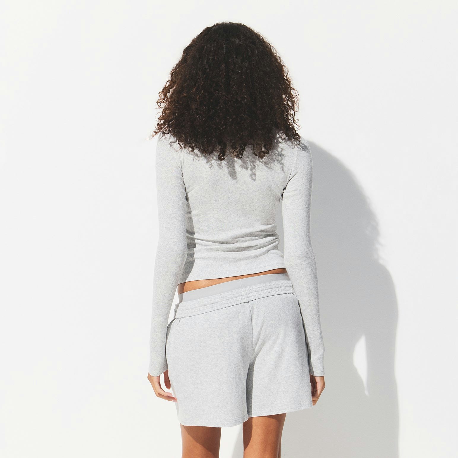 DROP NEEDLE POINTELLE LONG SLEEVE TOP | LIGHT HEATHER GREY ON A MODEL BACK VIEW @ | FOCUS: 0.0, 1.0, 0.9