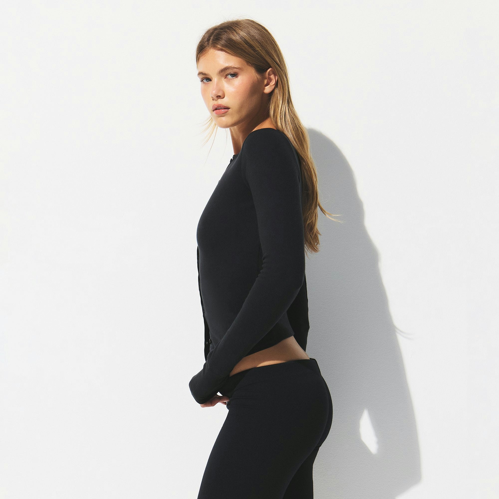 DROP NEEDLE POINTELLE LONG SLEEVE CARDIGAN | ONYX ON A MODEL SIDE VIEW @ | FOCUS: 0.0, 1.0, 0.9