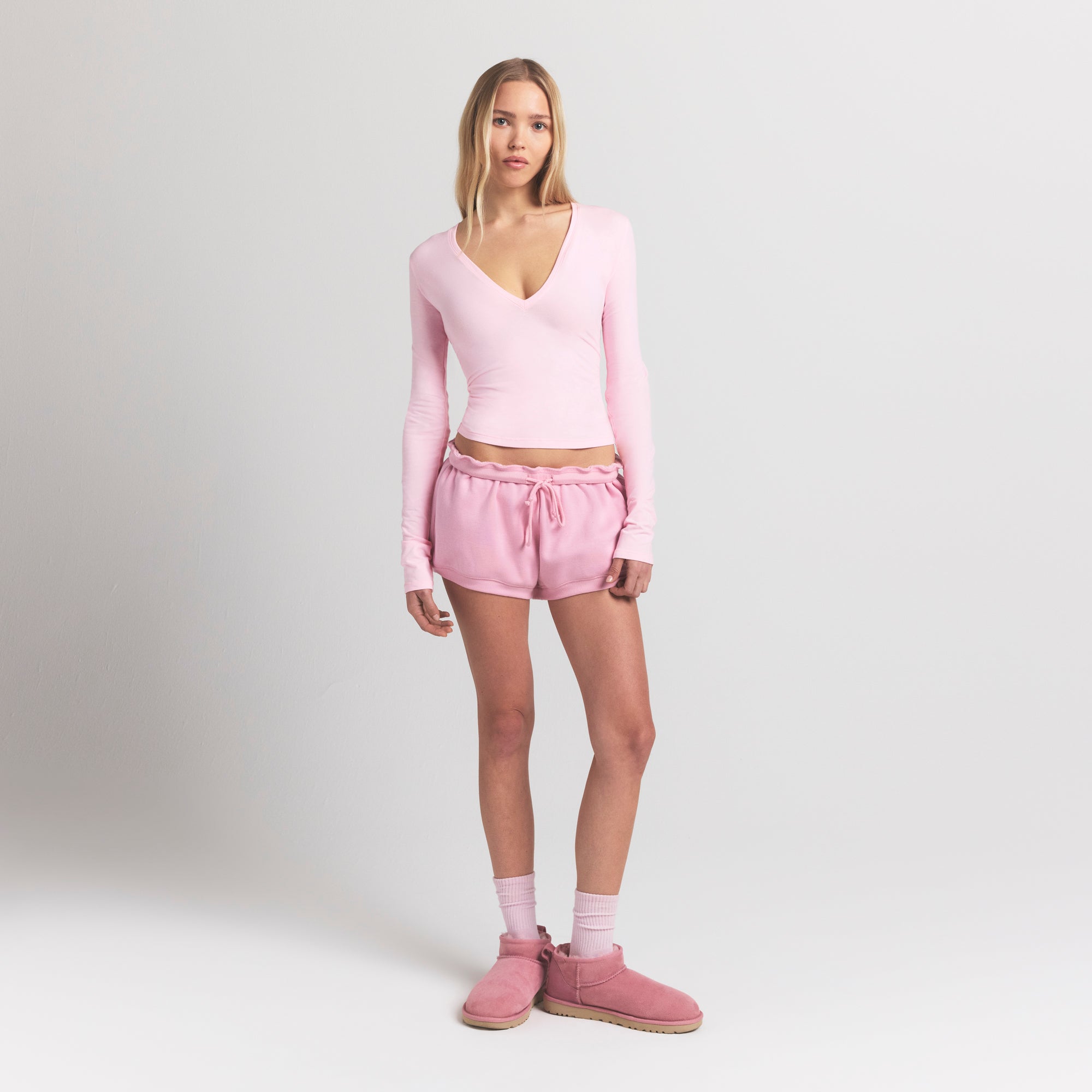 COTTON JERSEY LONG SLEEVE DEEP PLUNGE TOP | CHERRY BLOSSOM ON A MODEL FRONT VIEW @ | FOCUS: 0.9, 0.1, 0.7