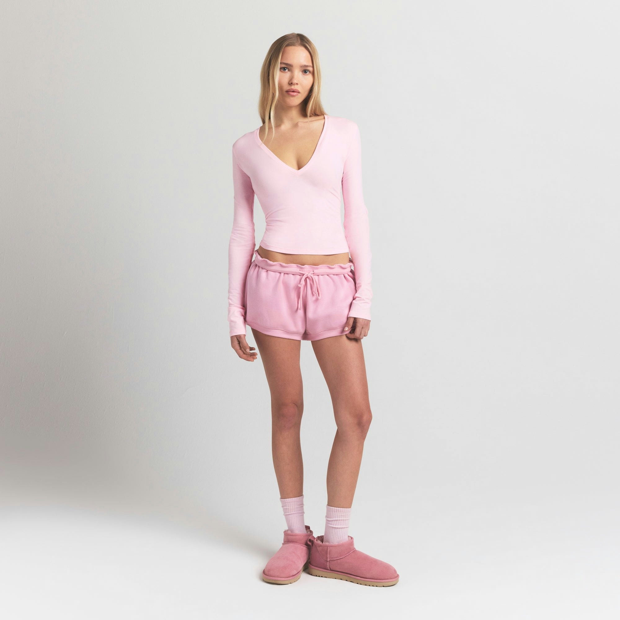 COTTON JERSEY LONG SLEEVE DEEP PLUNGE TOP | CHERRY BLOSSOM ON A MODEL FRONT VIEW @ | FOCUS: 0.9, 0.1, 0.7