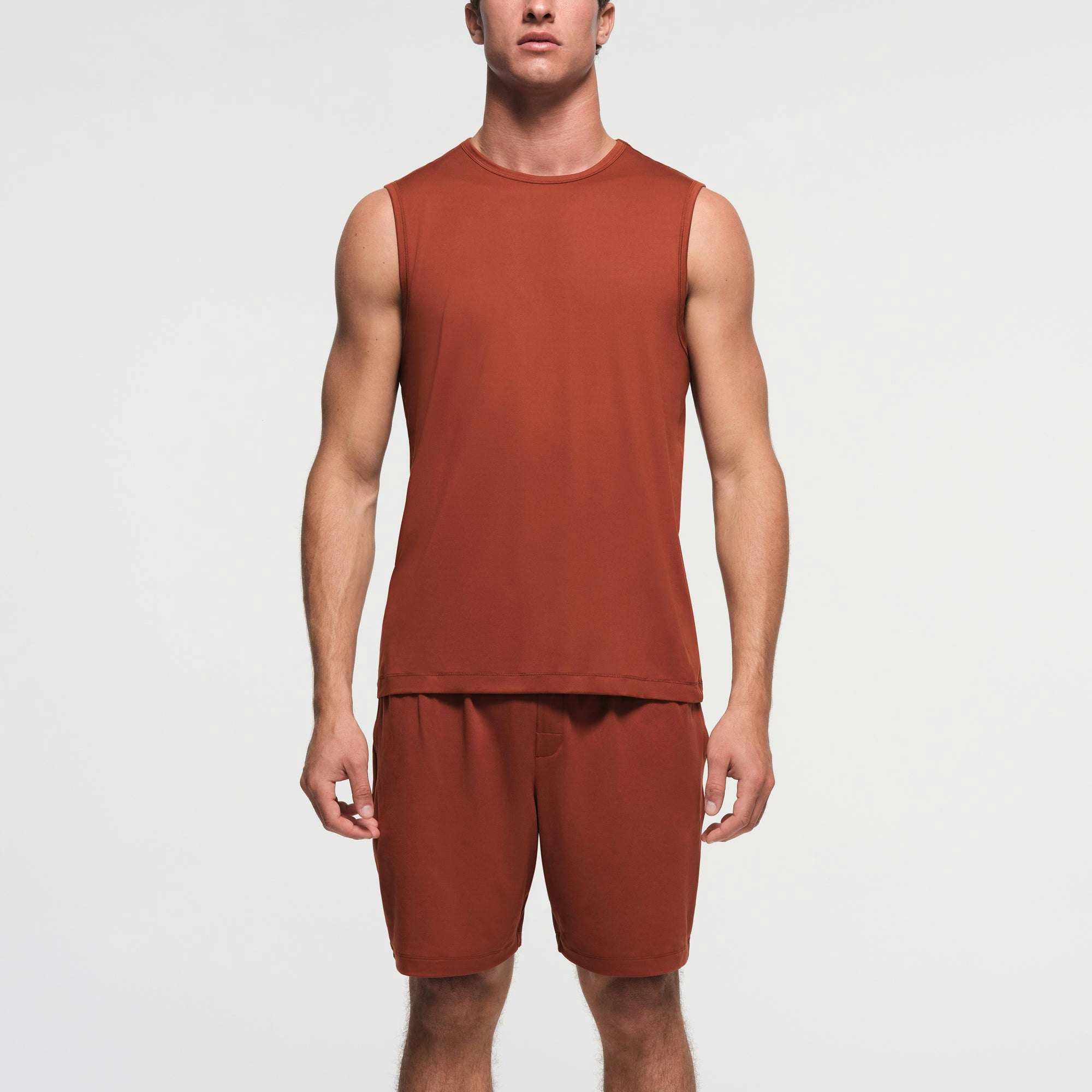 OUTDOOR JERSEY MENS MUSCLE TANK | RUST ON A MODEL FRONT VIEW