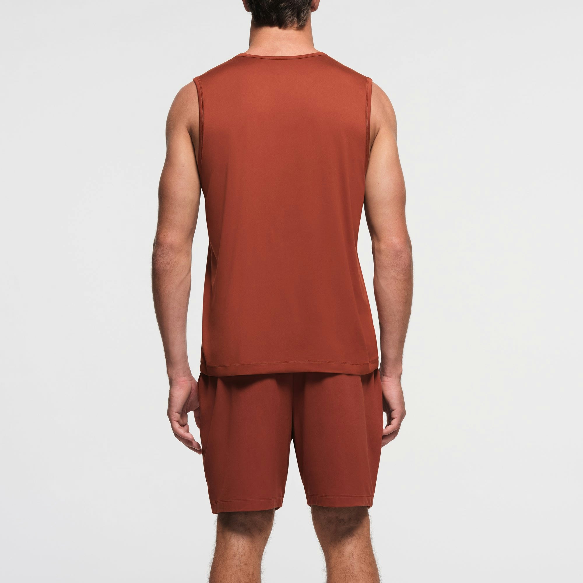OUTDOOR JERSEY MENS MUSCLE TANK | RUST ON A MODEL BACK VIEW