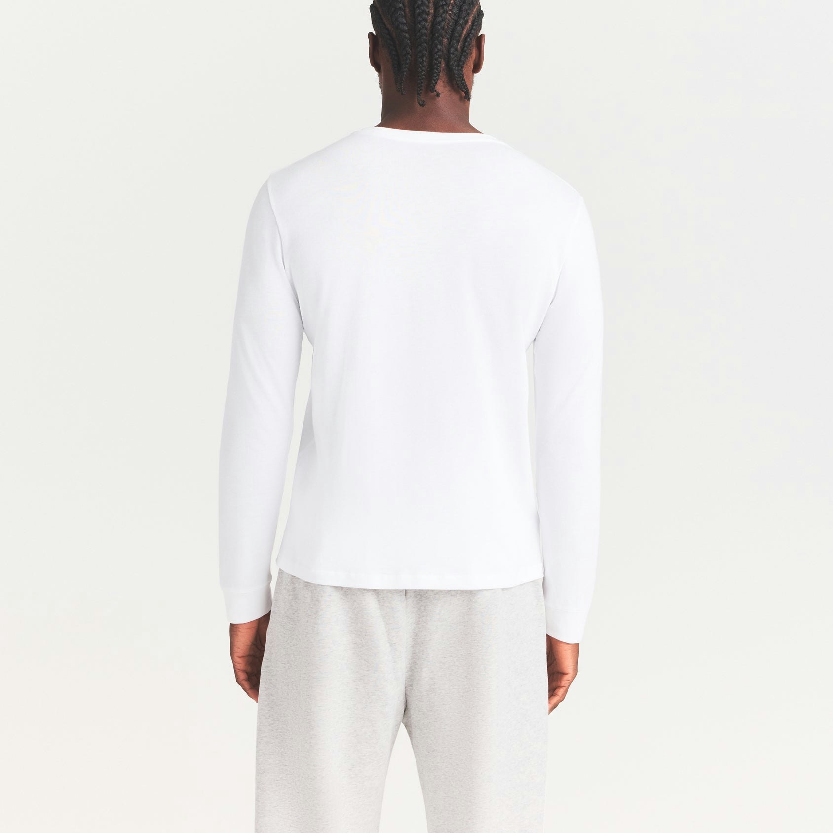 SKIMS COTTON MENS CLASSIC LONG SLEEVE T-SHIRT | CHALK ON A MODEL SIDE VIEW | FOCUS: 0.0, 1.0, 0.9