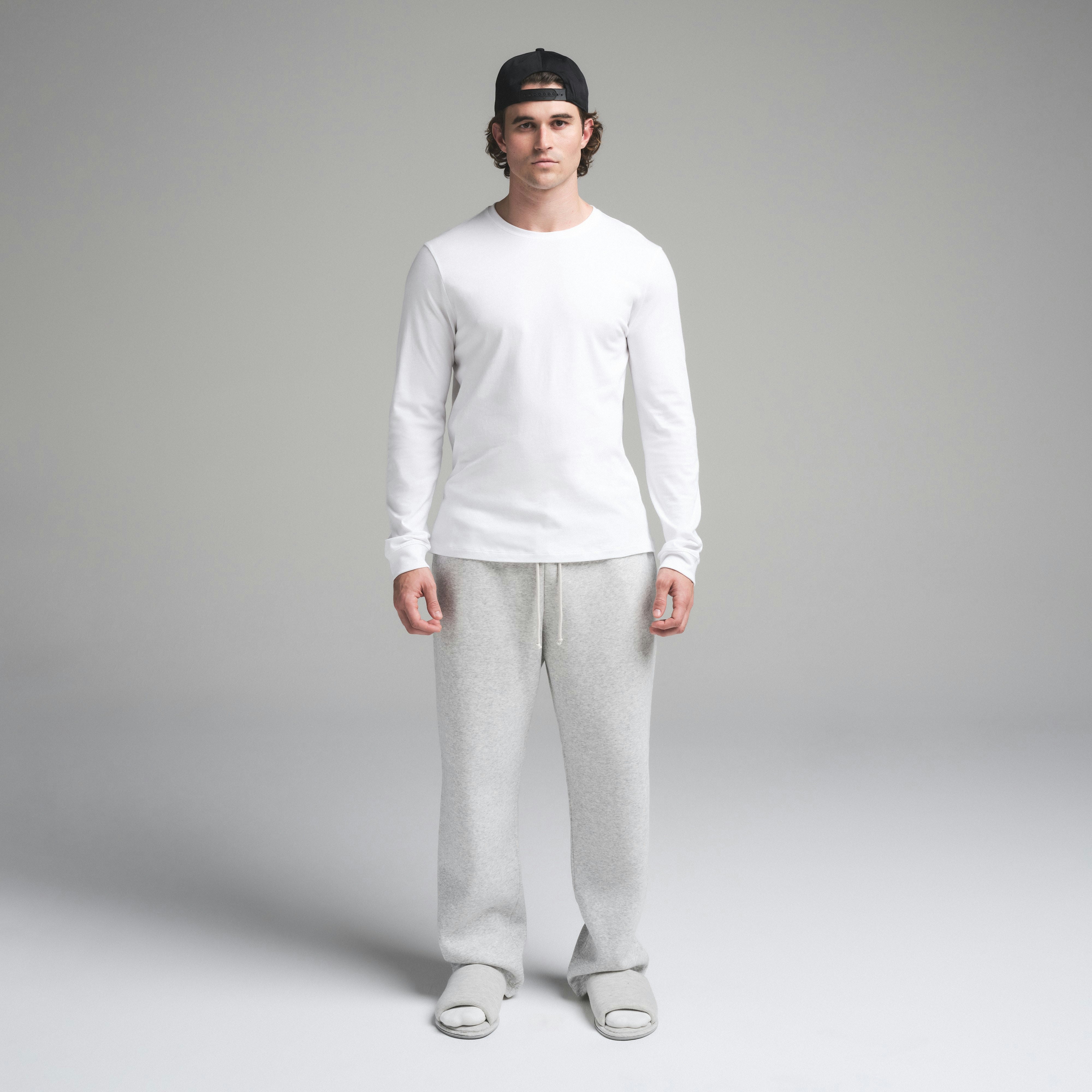 SKIMS COTTON MENS CLASSIC LONG SLEEVE T-SHIRT | CHALK ON A MODEL FRONT VIEW | FOCUS: 0.0, 1.0, 0.9