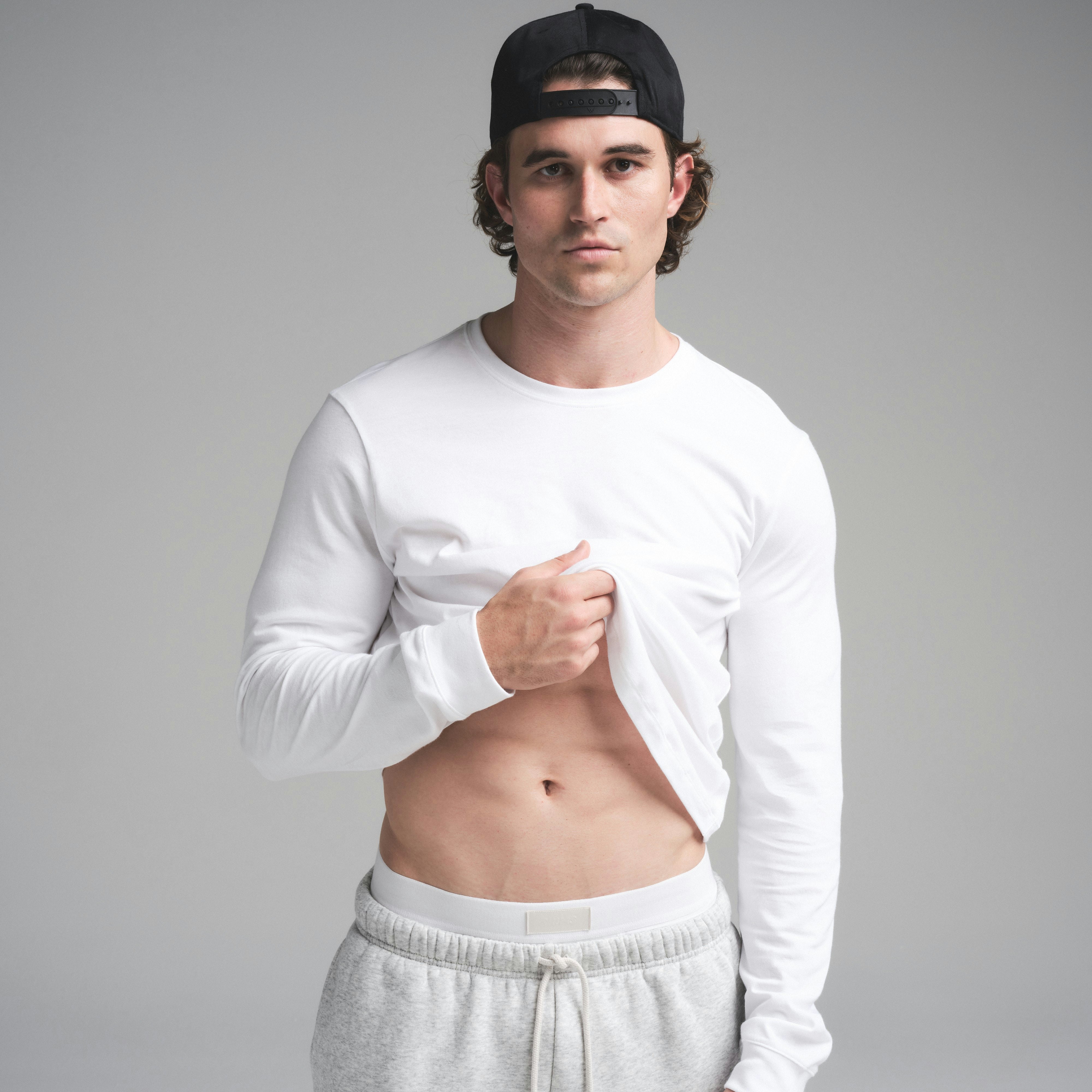 SKIMS COTTON MENS CLASSIC LONG SLEEVE T-SHIRT | CHALK ON A MODEL SIDE VIEW | FOCUS: 0.0, 1.0, 0.9