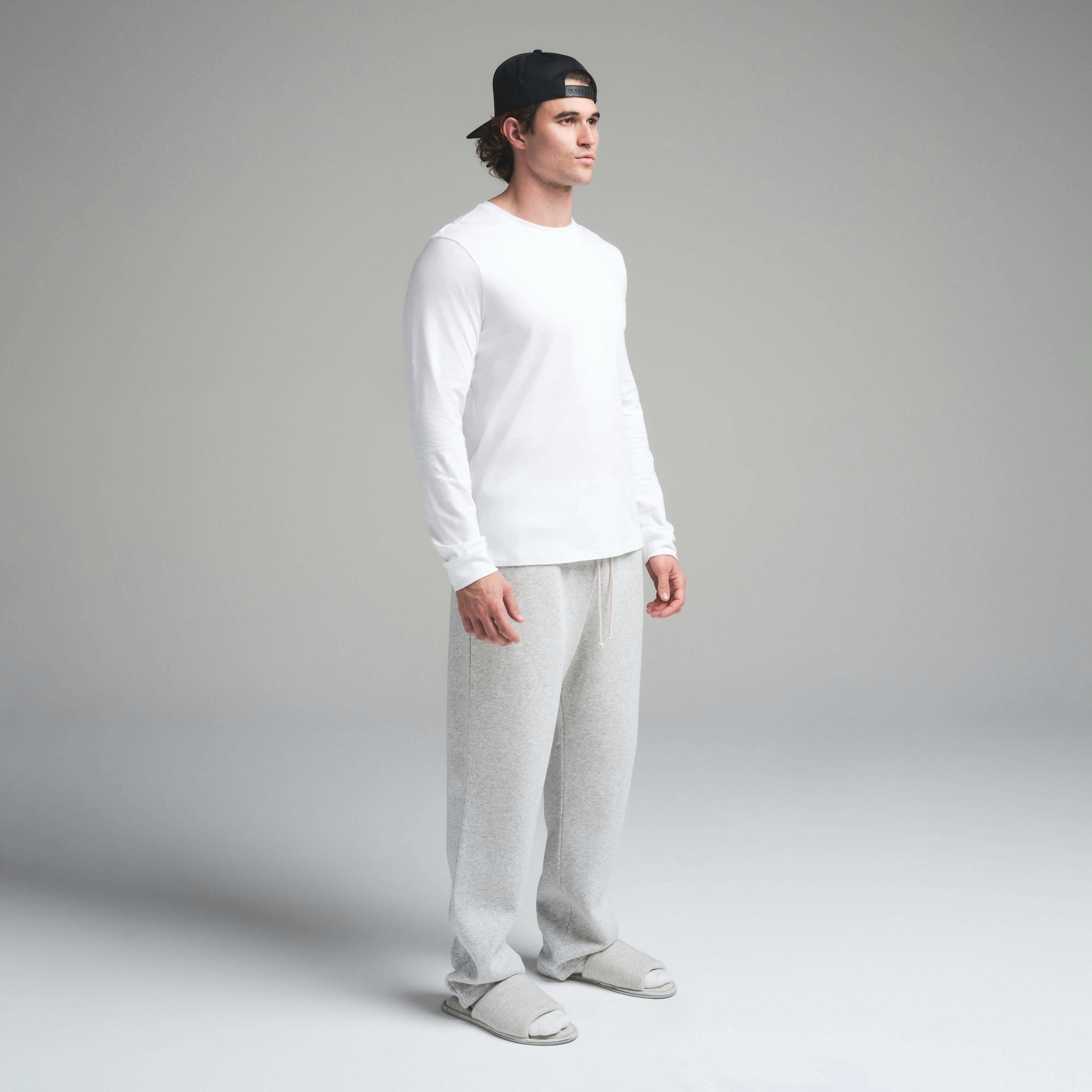 SKIMS COTTON MENS CLASSIC LONG SLEEVE T-SHIRT | CHALK ON A MODEL SIDE VIEW | FOCUS: 0.0, 1.0, 0.9