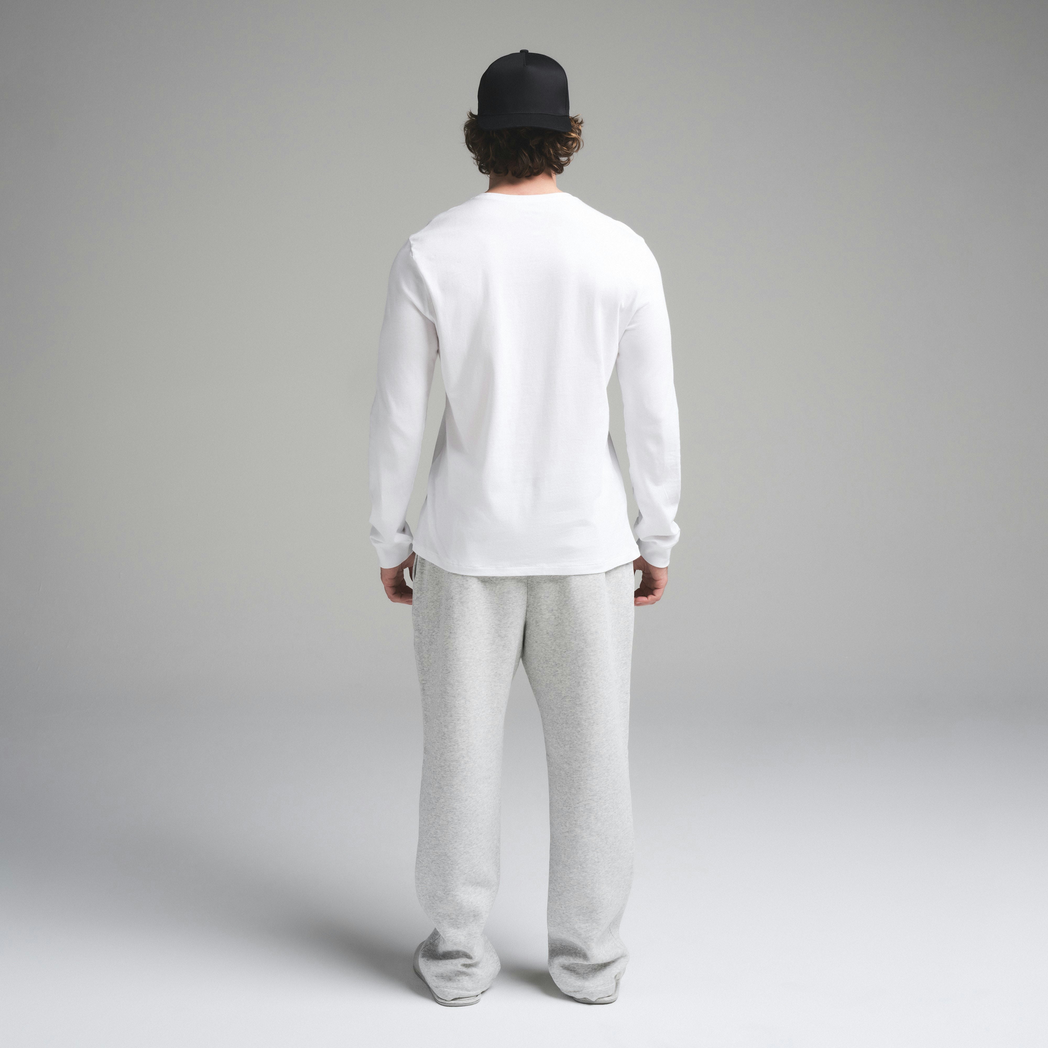 SKIMS COTTON MENS CLASSIC LONG SLEEVE T-SHIRT | CHALK ON A MODEL SIDE VIEW | FOCUS: 0.0, 1.0, 0.9