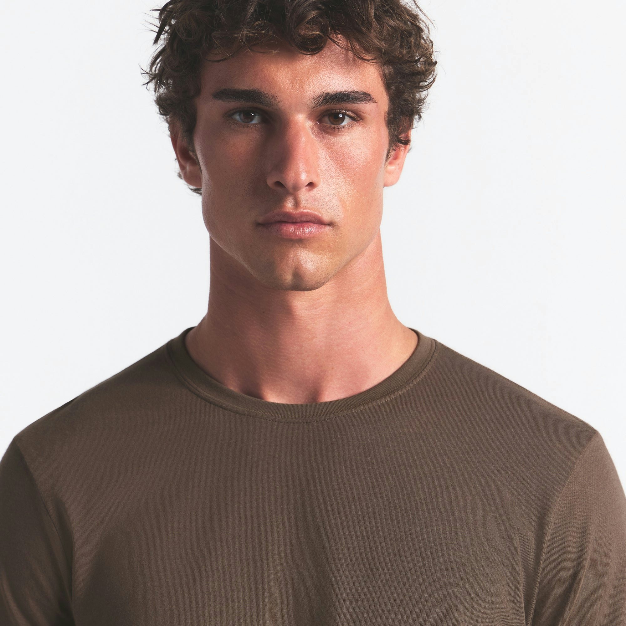 SKIMS COTTON MENS CLASSIC LONG SLEEVE T-SHIRT | DRIFTWOOD ON A MODEL FRONT VIEW @ | FOCUS: 0.0, 1.0, 0.9